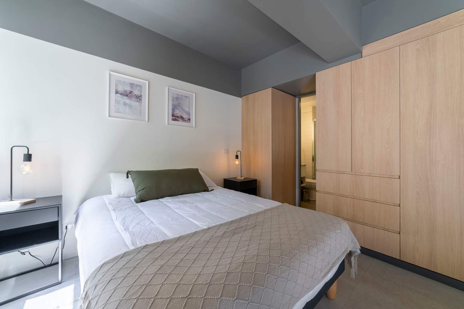 Relax in this cozy bedroom with modern decor and ample storage, perfect for a restful night's sleep.