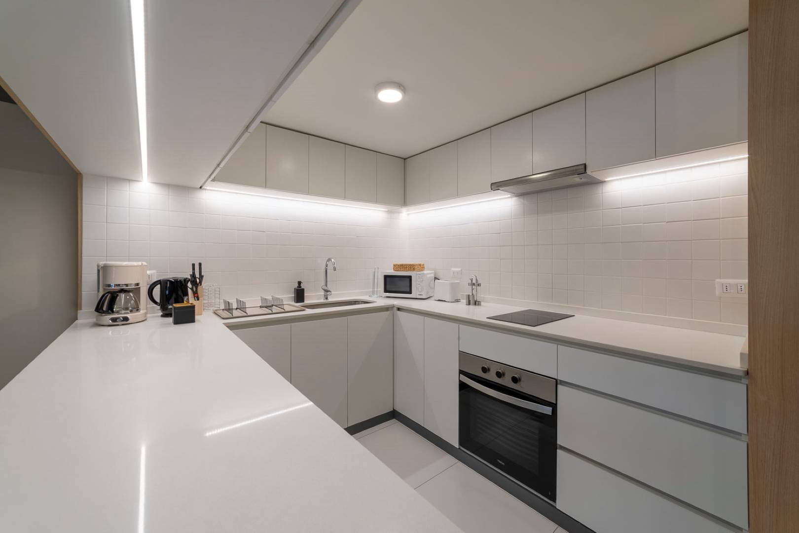 Cook in style in this sleek, modern kitchen with high-end appliances and ample counter space for your culinary creations.