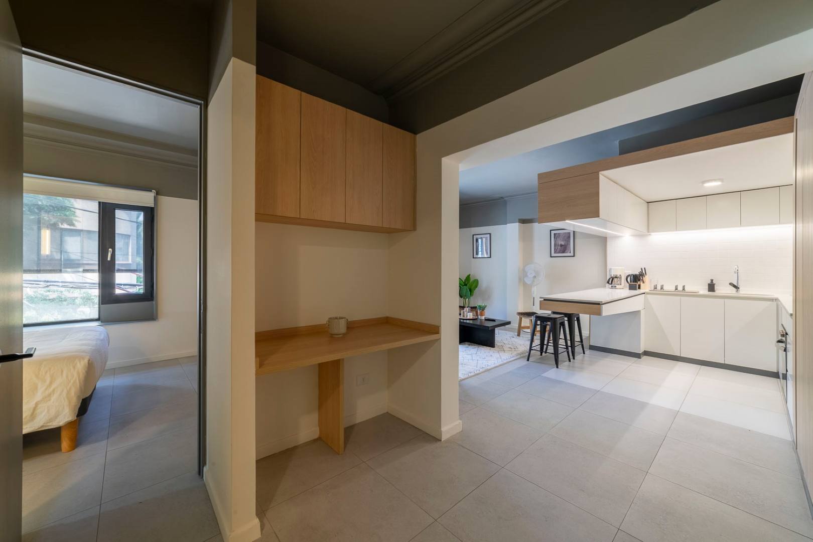 Discover modern comfort in this studio with a stylish kitchen and cozy workspace, perfect for a relaxing stay.