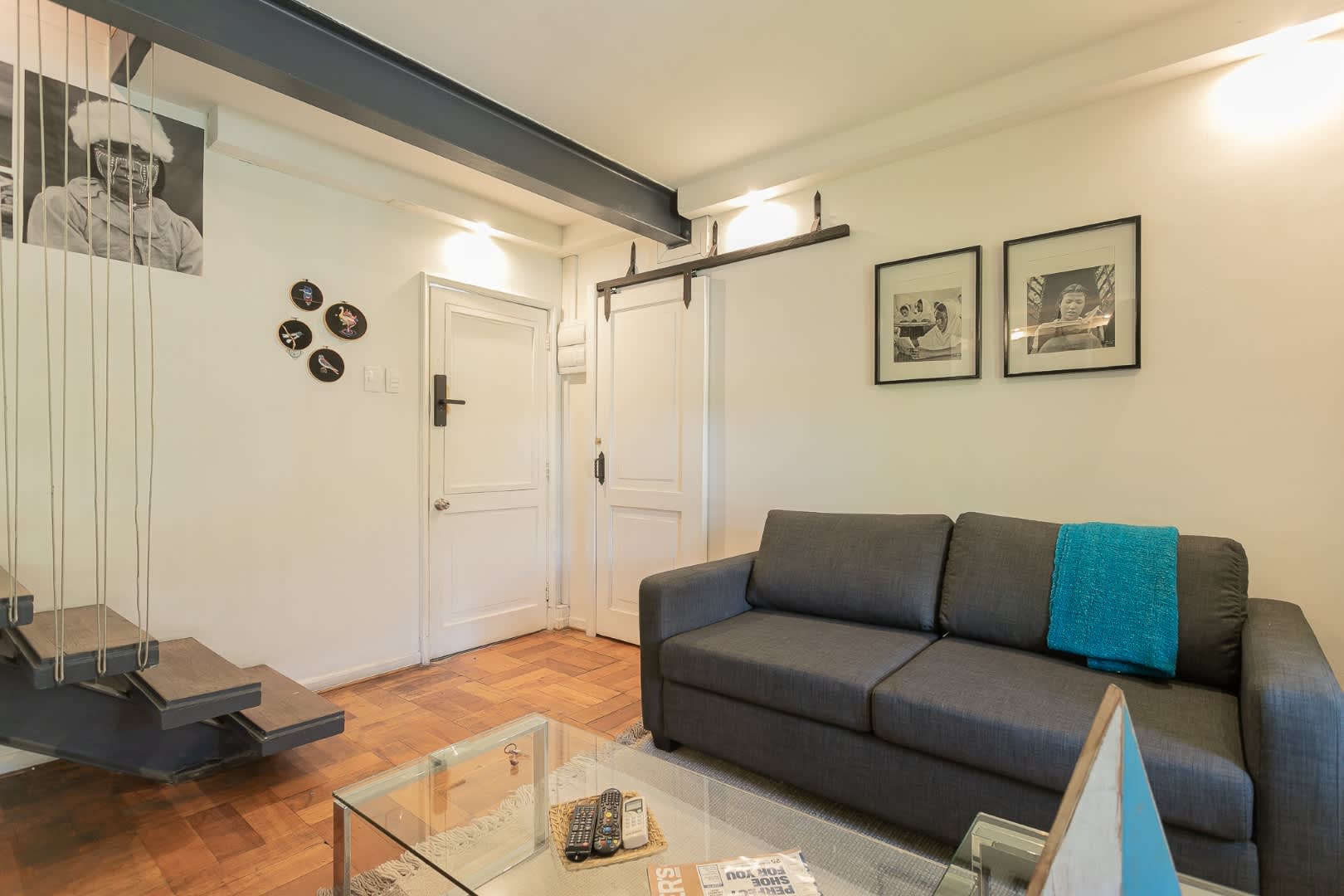 Cozy living room with modern decor and a unique floating staircase, perfect for relaxing after a day of exploring.