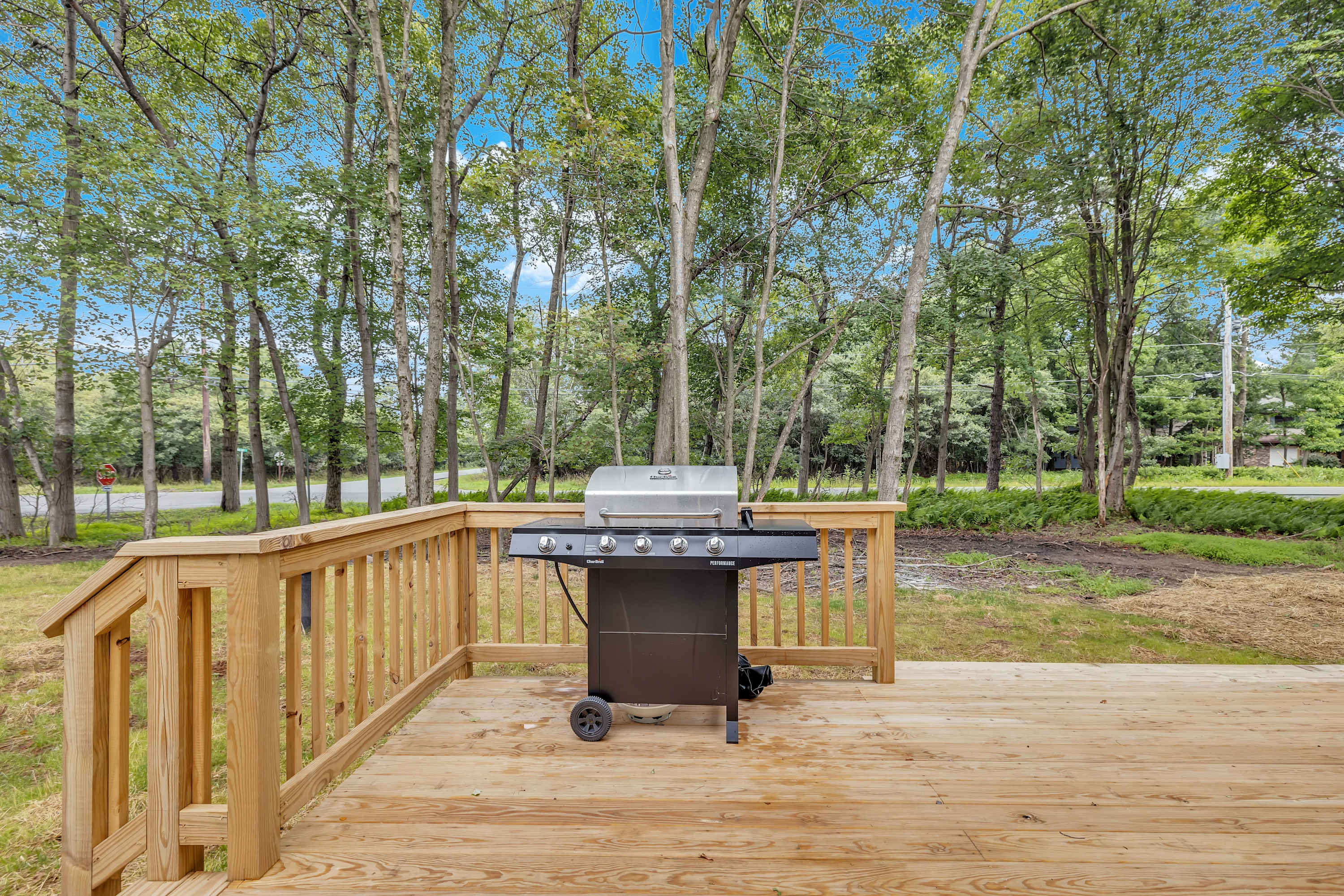 Expansive Deck with Nature Views – A wide-open deck surrounded by lush greenery, offering a tranquil outdoor escape.