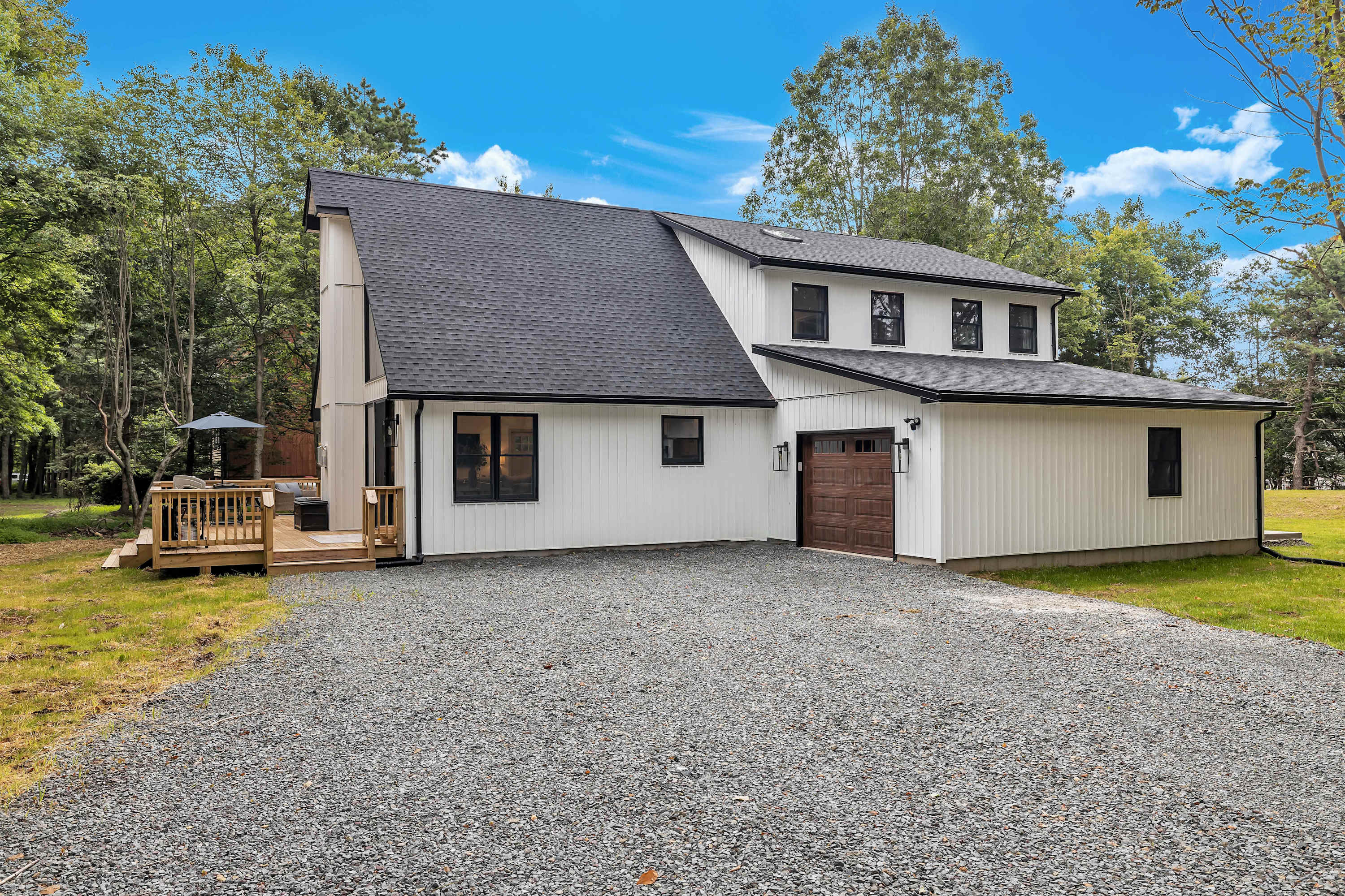 Spacious & Stylish Main House – A beautifully designed home with a sleek exterior, ample parking, and a peaceful setting surrounded by nature.
