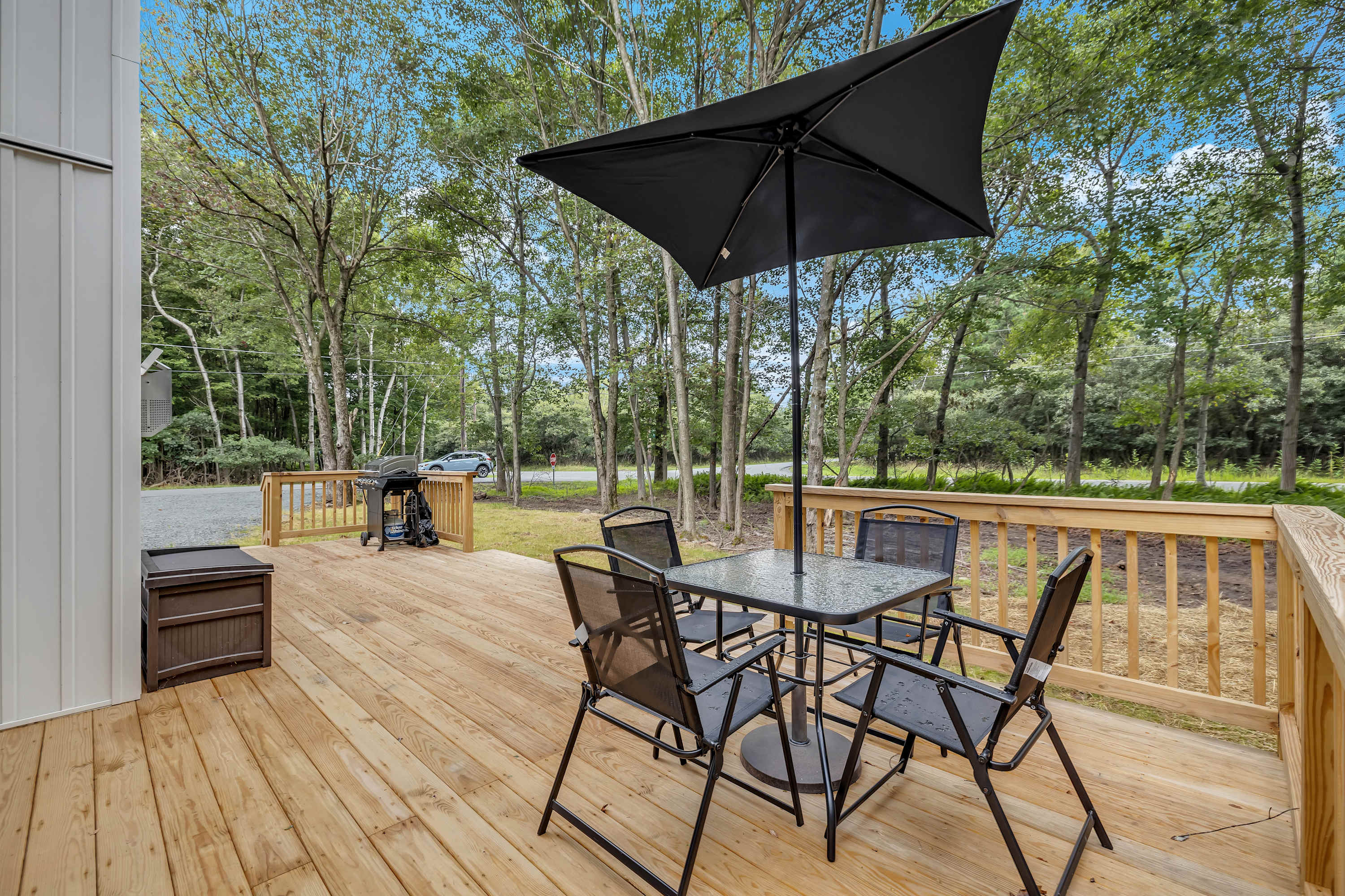 Outdoor Dining & Lounge Area – A stylish dining setup with an umbrella for shade, perfect for al fresco meals and relaxation.