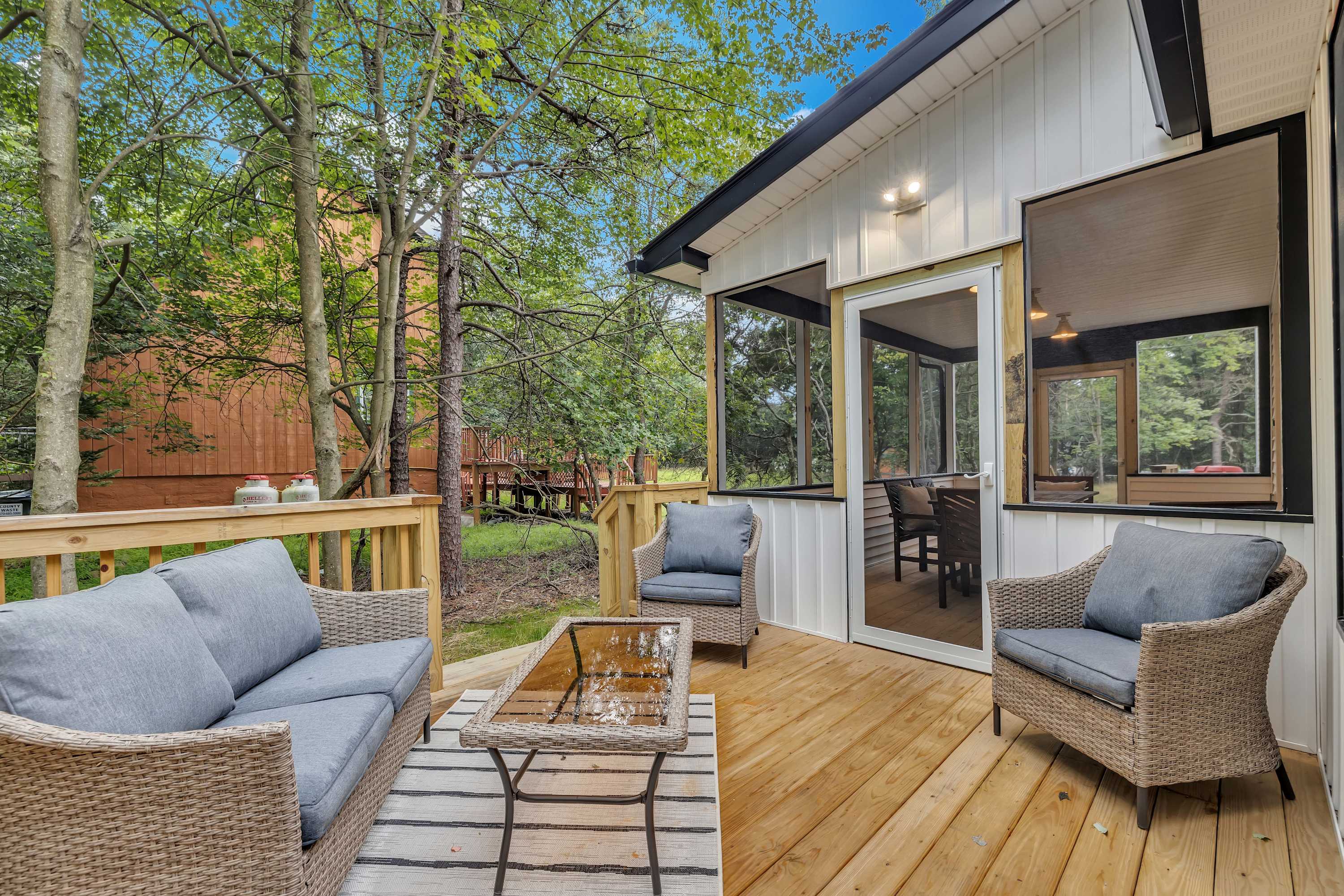 Relax in Style on the Deck – A serene outdoor seating area with comfortable wicker furniture, offering a perfect spot to unwind in the fresh air.