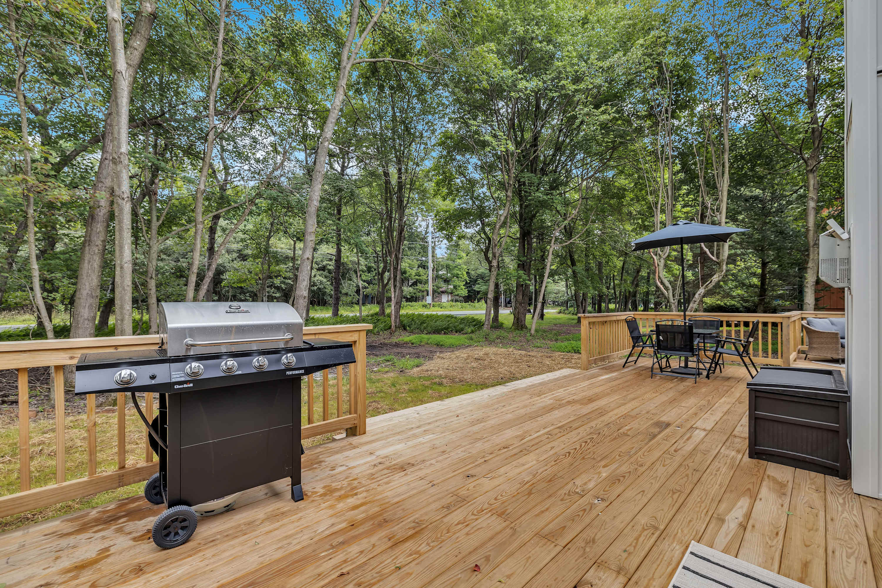 The Ultimate Grilling Spot – A spacious deck featuring a high-quality grill, perfect for barbecues and outdoor feasts with a view.