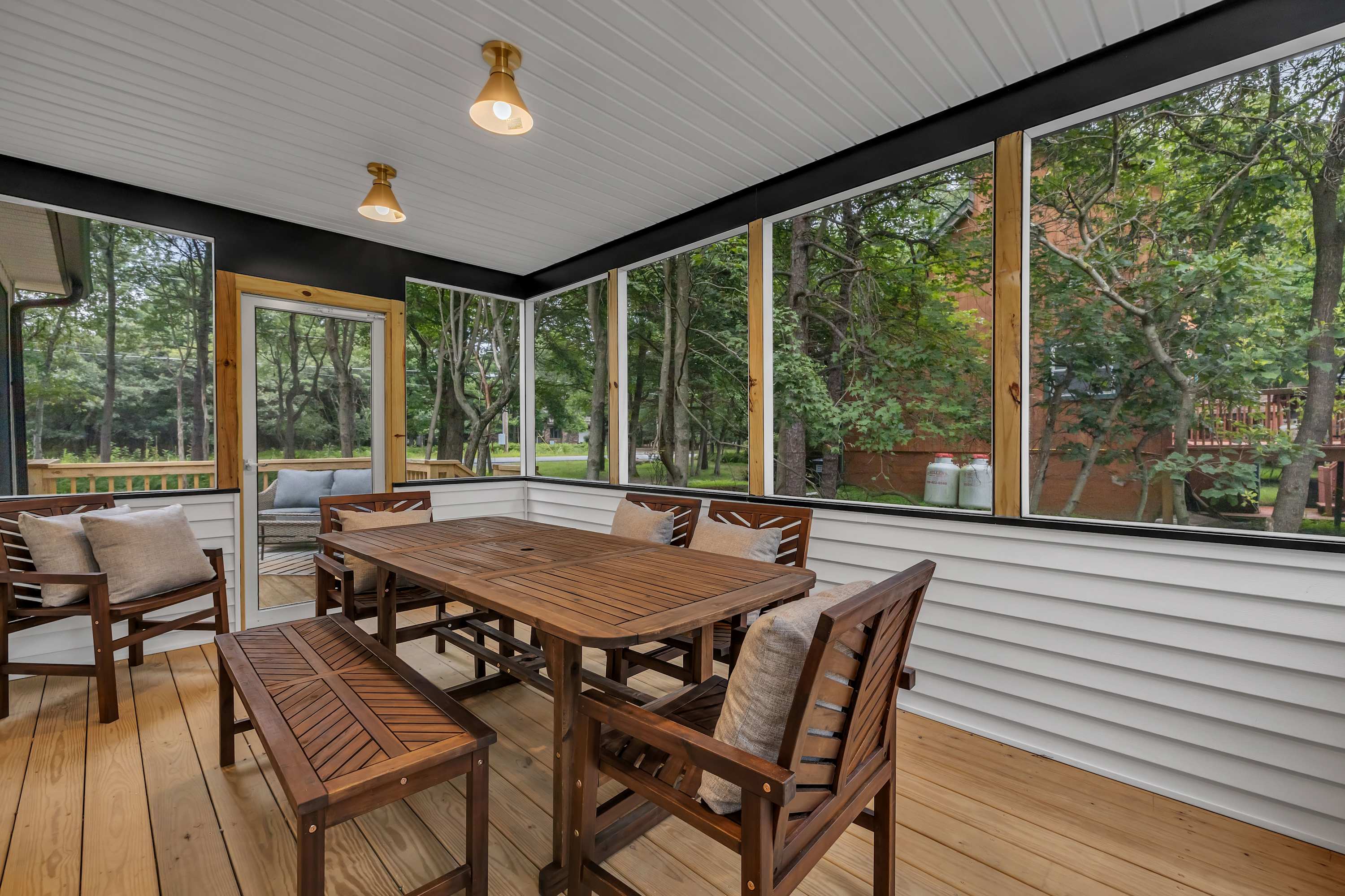 Screened-In Dining with a View – Enjoy meals in this charming enclosed patio, offering fresh air, cozy seating, and a seamless indoor-outdoor experience.