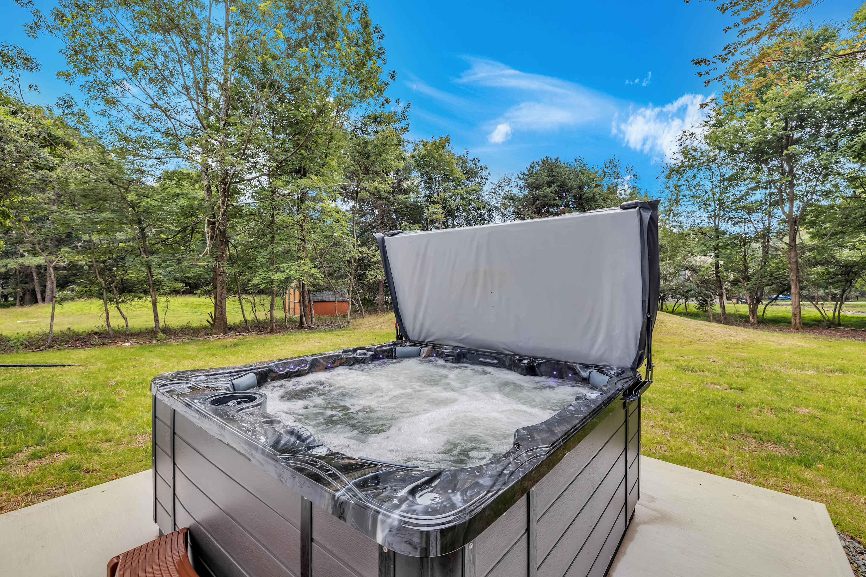 Serene Spa Experience – A luxurious hot tub in the heart of nature, inviting you to soak and de-stress under the open sky.