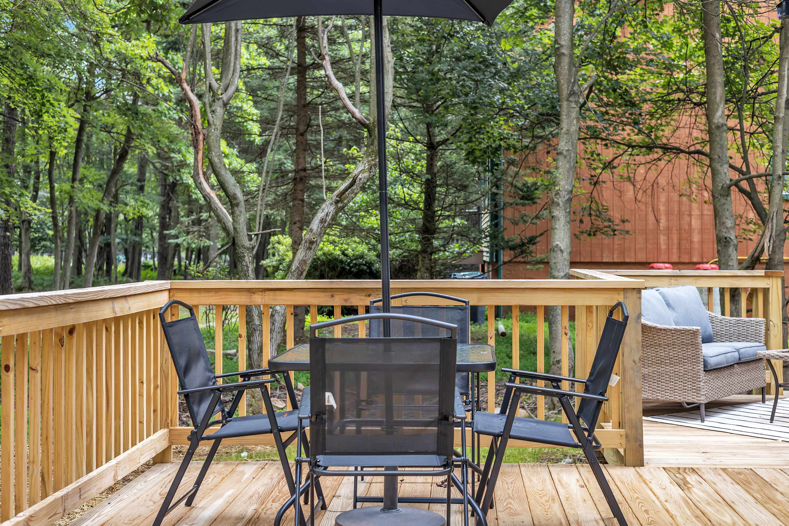 Dining & Lounge Under the Trees – A stylish outdoor dining set with a shaded umbrella, making it the perfect spot for a casual meal surrounded by nature.