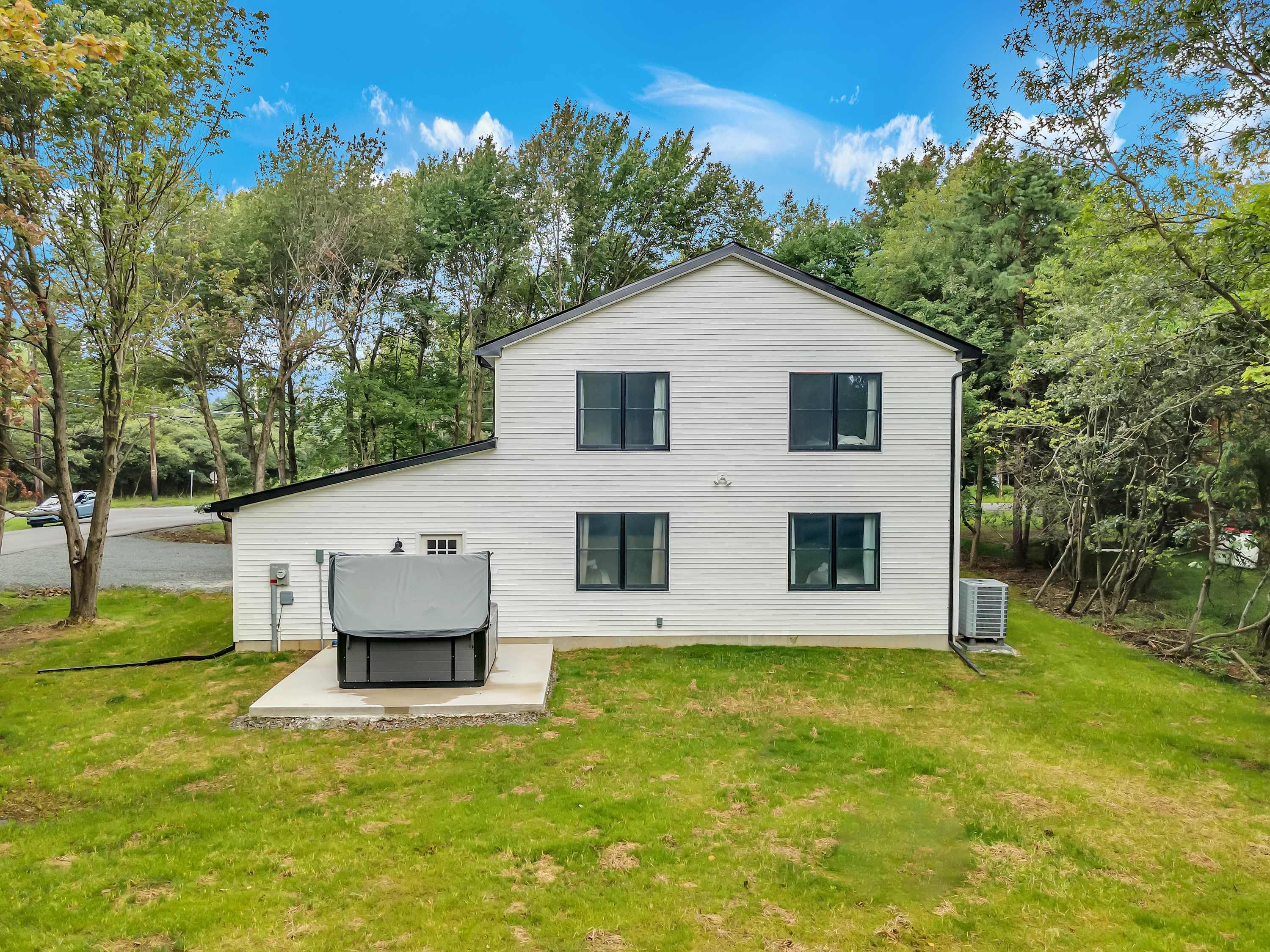 Modern & Minimalist Guest House – A charming white guest house surrounded by greenery, offering a private and peaceful retreat.