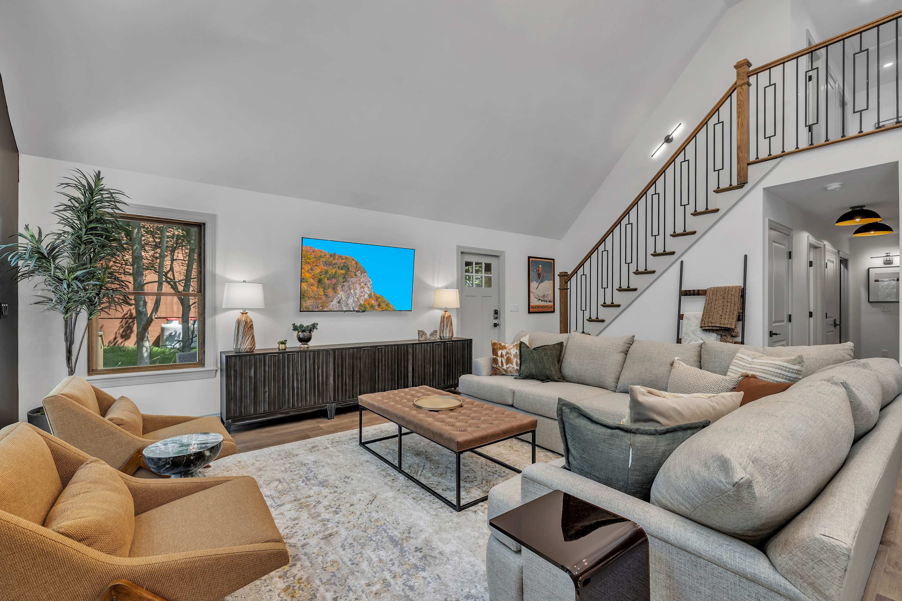 Bright & Spacious Living Room – A stunning open-concept living space with vaulted ceilings, plush seating, and elegant décor, perfect for gathering and unwinding.