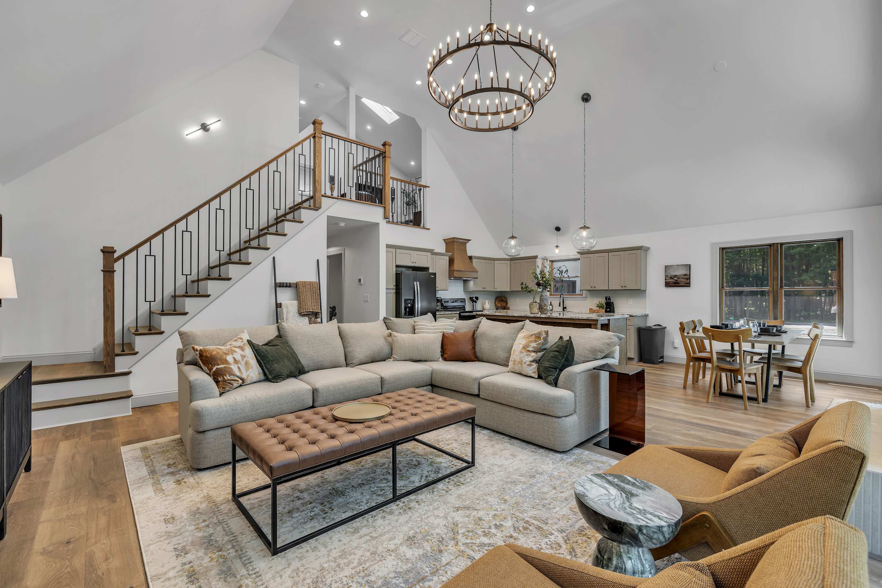 Sophisticated & Airy Lounge Area – A perfect blend of comfort and elegance, featuring an oversized sectional, a statement chandelier, and a beautiful lofted design.