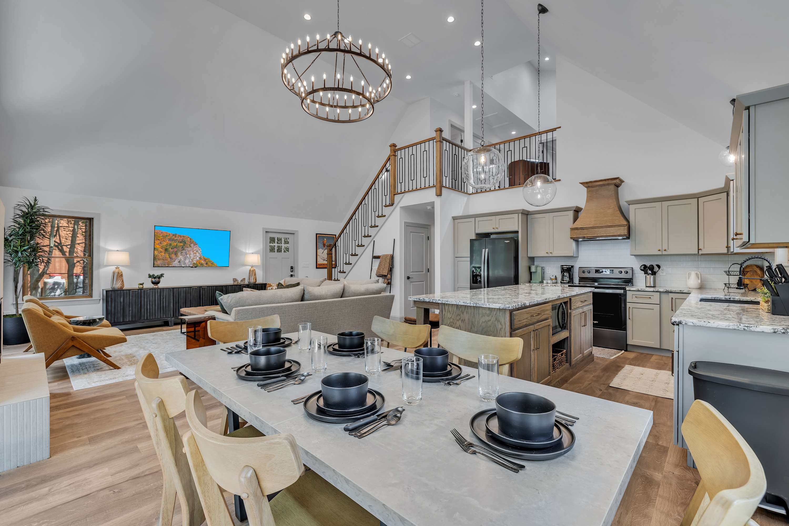 Elegant Dining & Entertaining Space – A spacious dining table set for a feast, perfectly positioned under a striking chandelier for a luxurious touch.