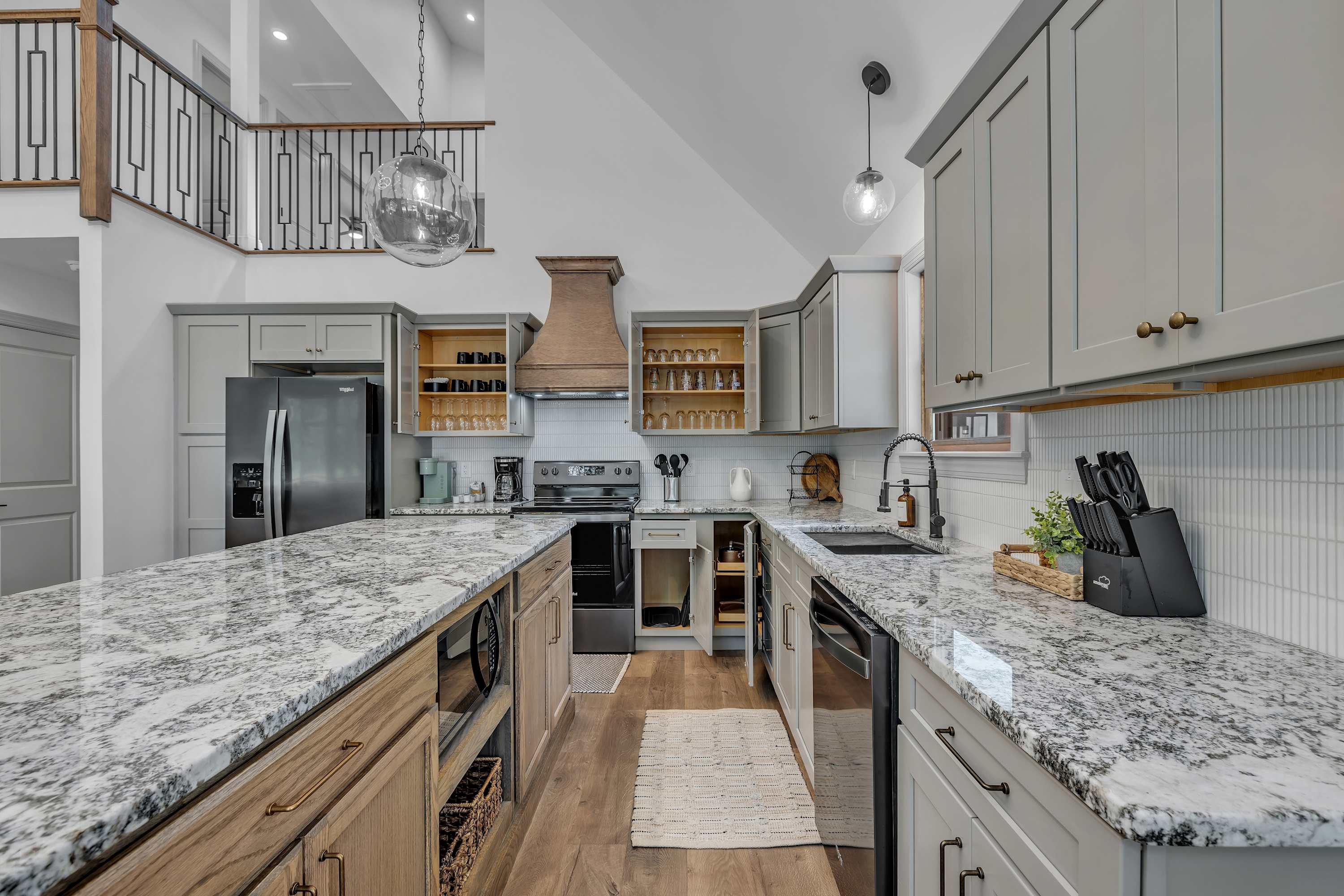 Modern & Rustic Kitchen Charm – A stylish kitchen with warm wood accents, elegant lighting, and a spacious island designed for both cooking and socializing.