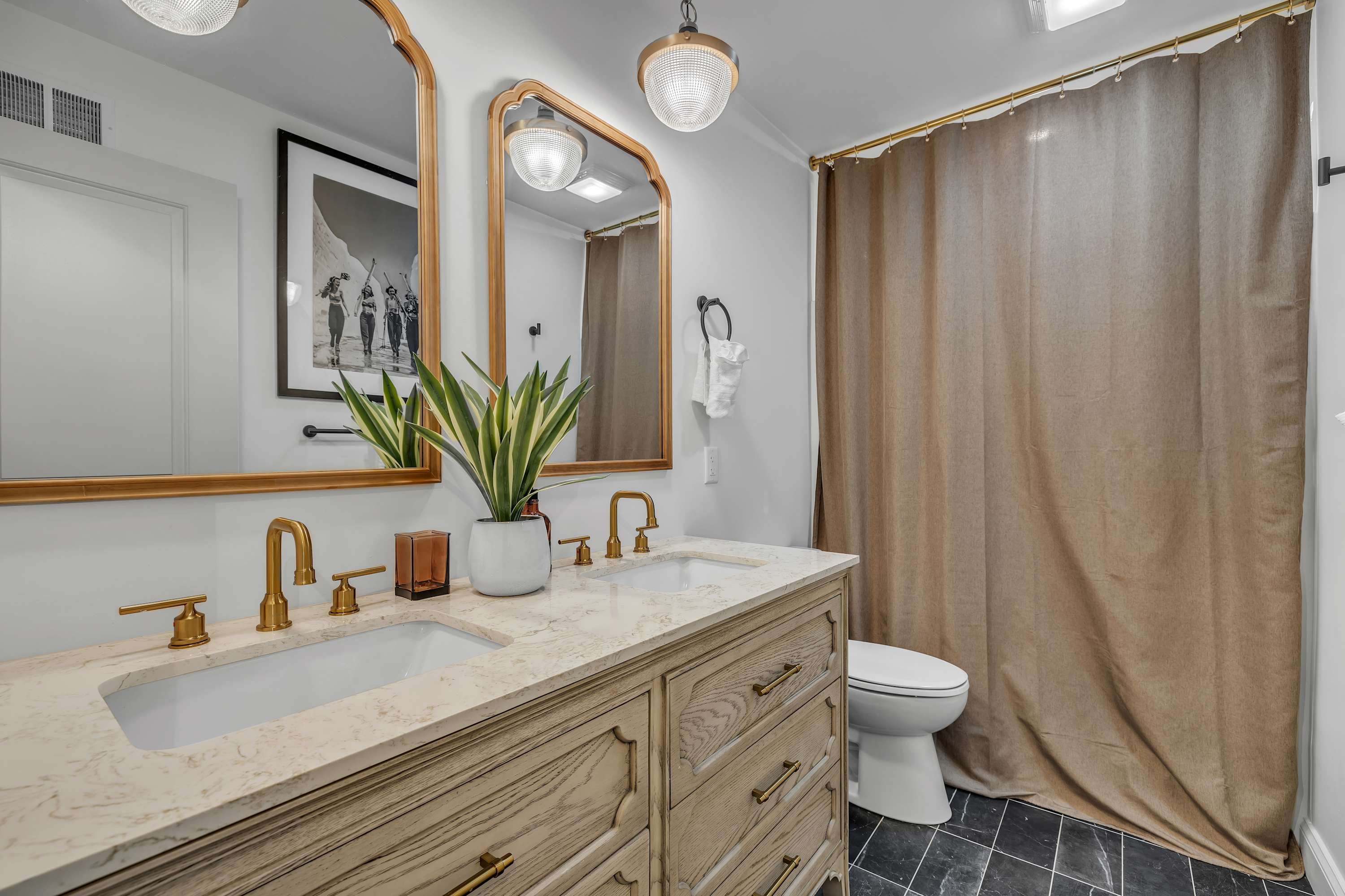 Elegant & Cozy Bathroom Retreat – A beautifully designed bathroom featuring gold fixtures, a warm wood vanity, and soft lighting for a spa-like experience.