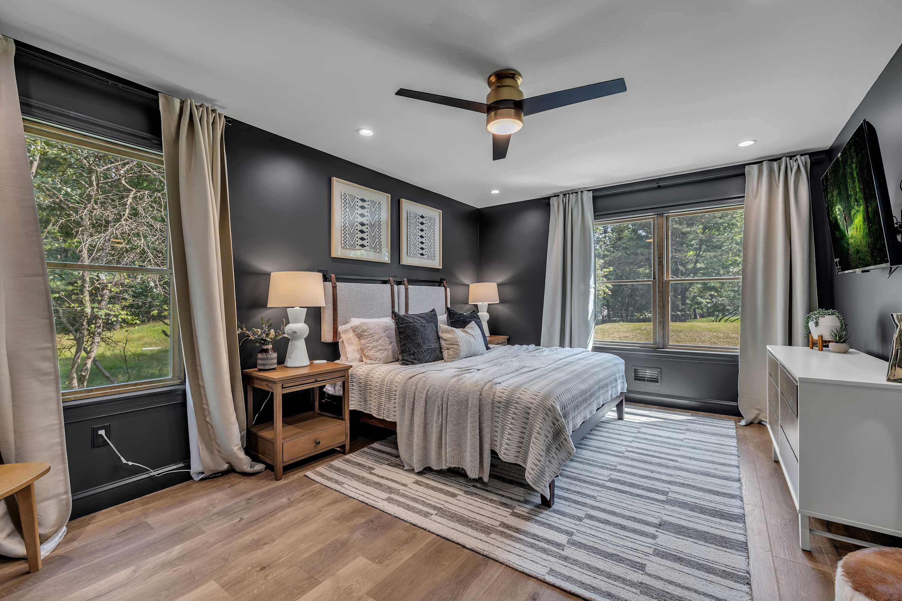 Serene & Stylish Primary Bedroom – A spacious retreat with floor-to-ceiling windows, soft neutral tones, and cozy bedding for the perfect night's sleep.