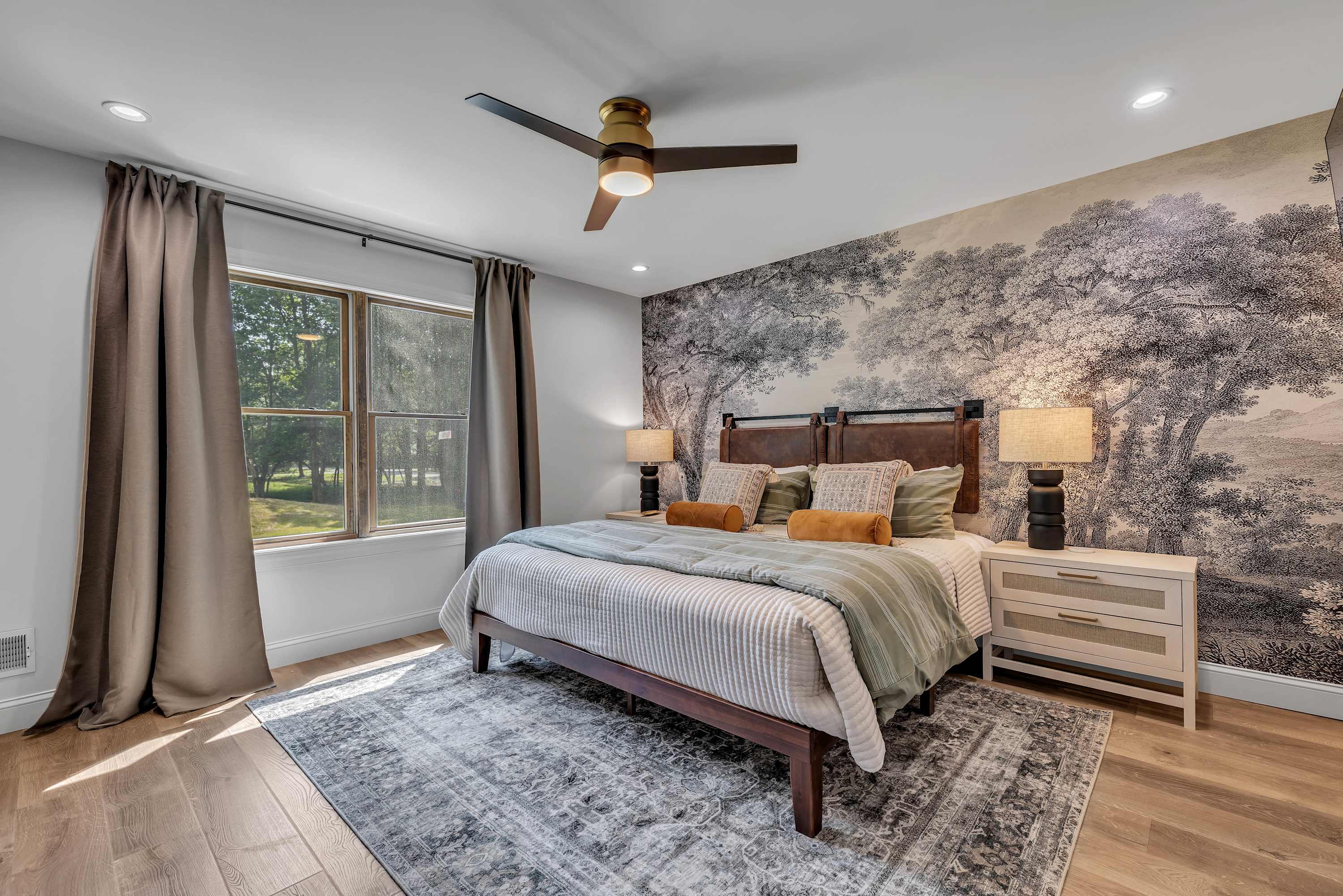 A Cozy Escape with Scenic Views – Floor-to-ceiling windows and soft textures make this bedroom an inviting space to unwind and recharge.