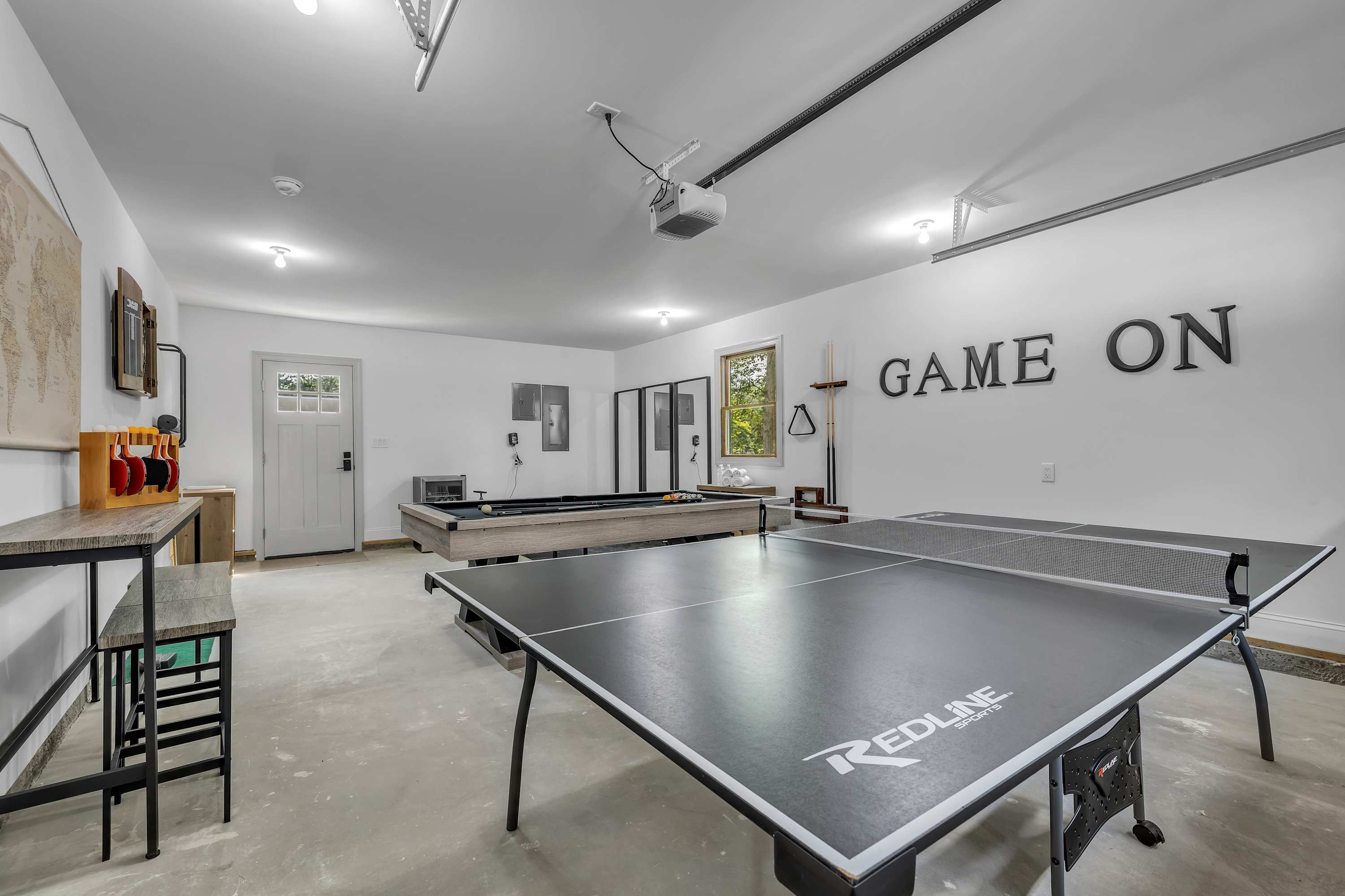 Game On in the Ultimate Rec Room – A spacious game room featuring a sleek ping pong table, perfect for friendly competitions and fun-filled moments.