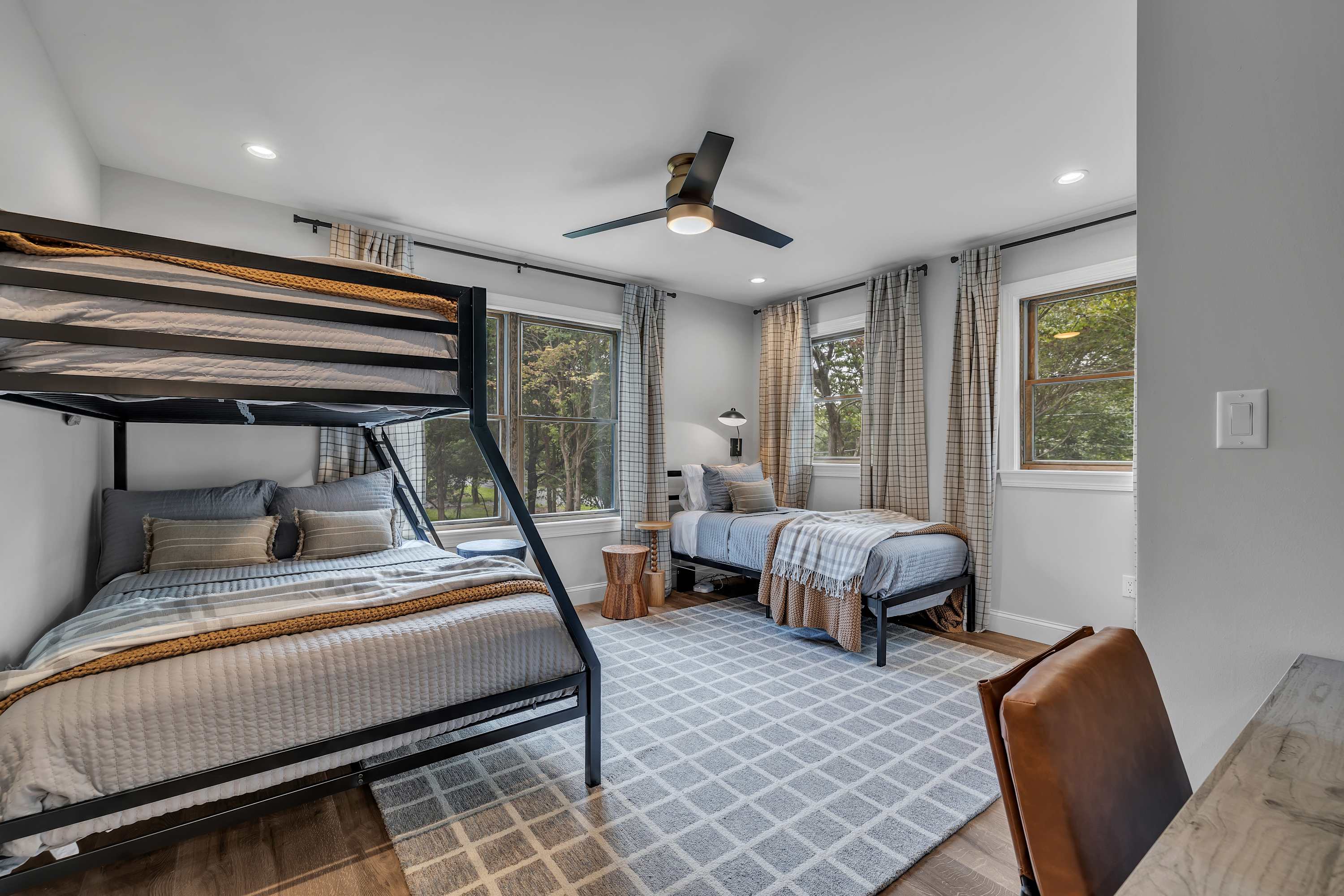 Spacious & Functional Sleeping Arrangement – A mix of single and bunk beds makes this room perfect for families or groups, blending comfort with style.