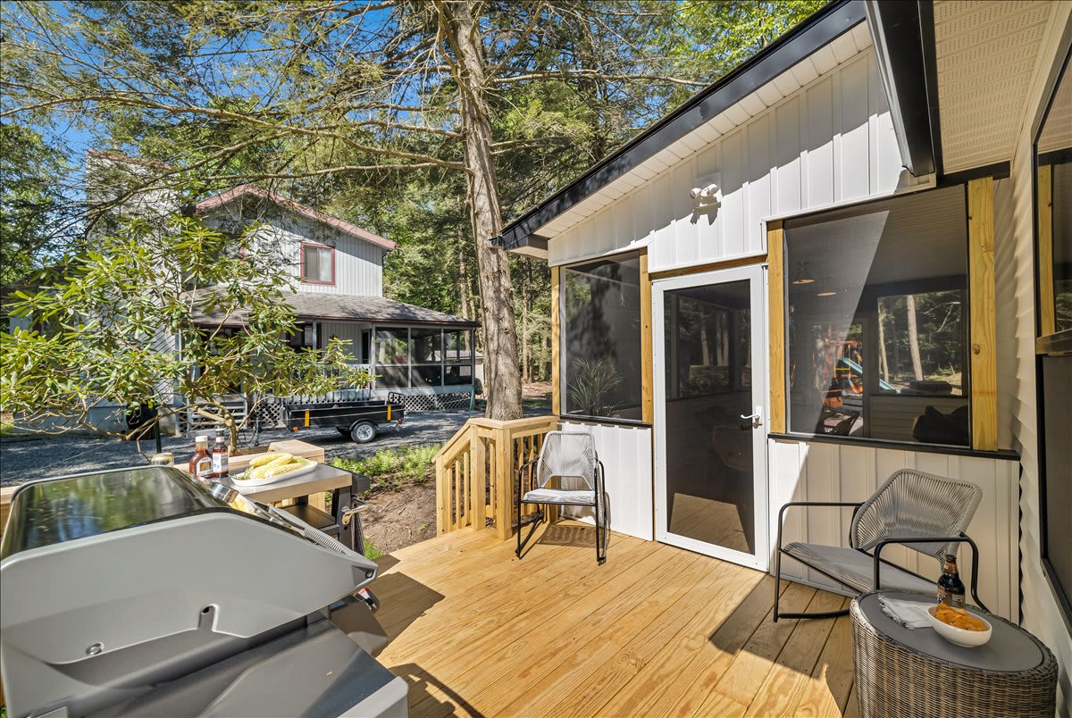 Follow the wrap-around deck to our sun room where you will find our front door! (Inside of the sun room)