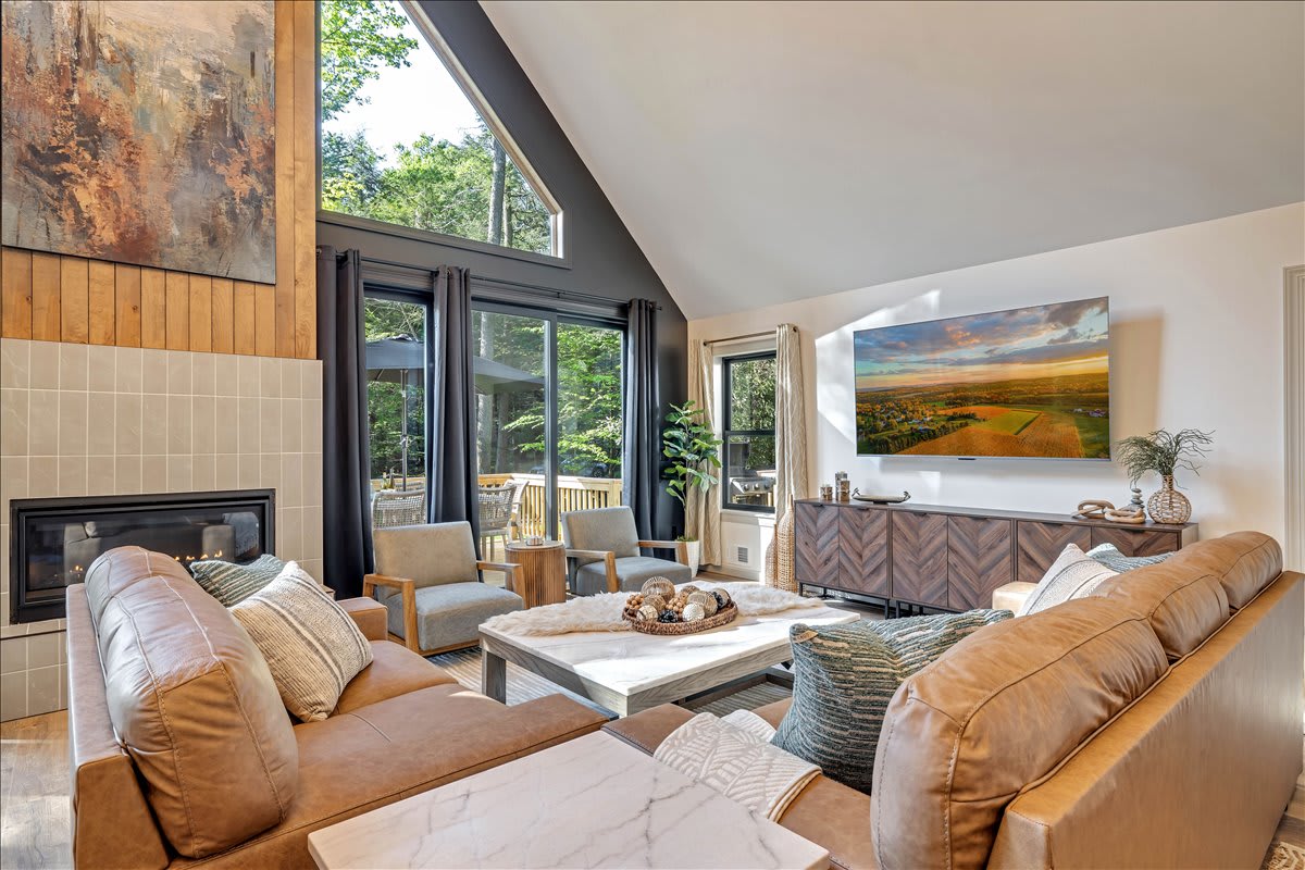 Relax in the spacious living room, complete with luxurious seating, a gas fireplace, and a large screen Roku TV – ideal for unwinding after a day of exploring.