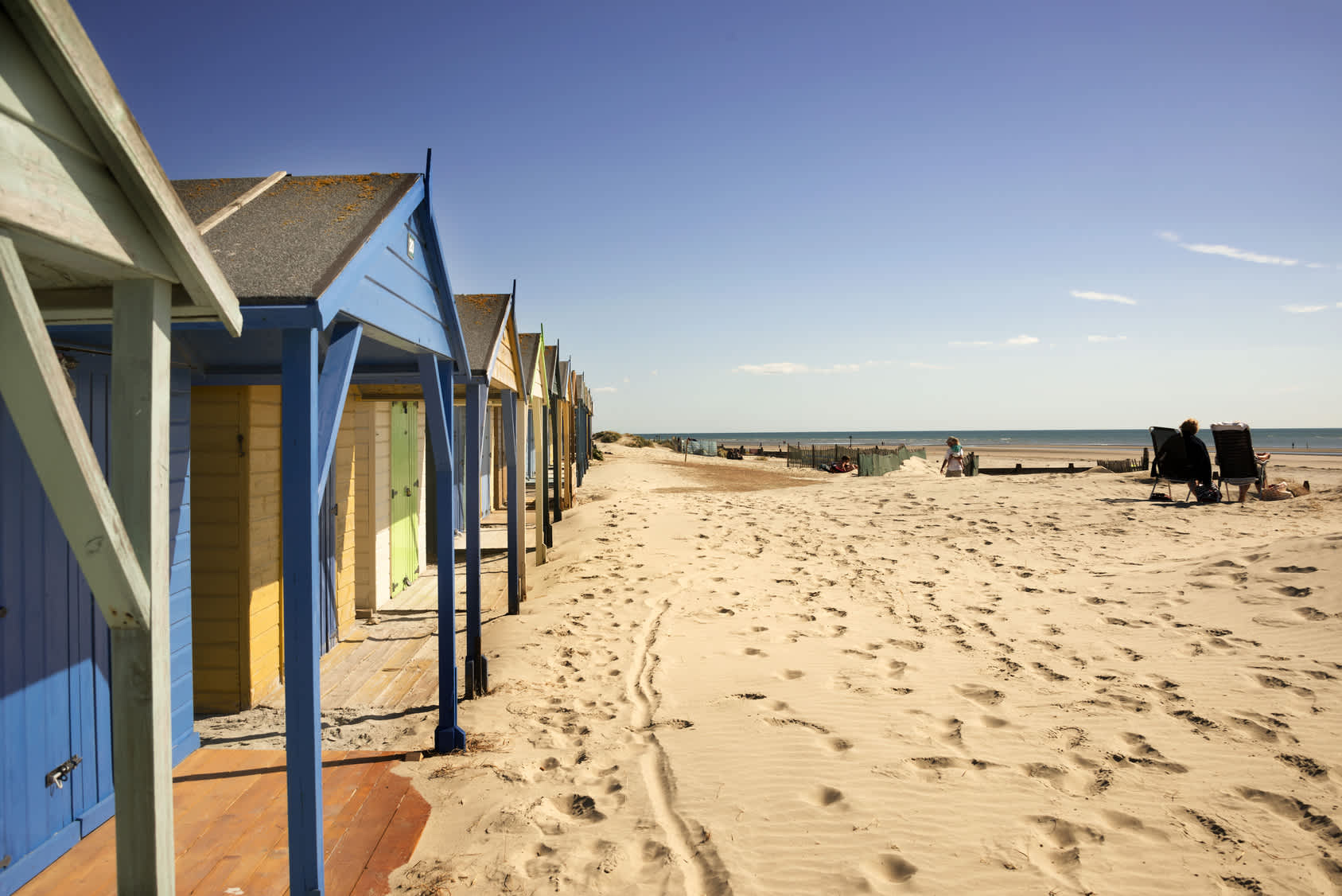 Colourful beach huts at West Wittering's sandy blue flag beach.