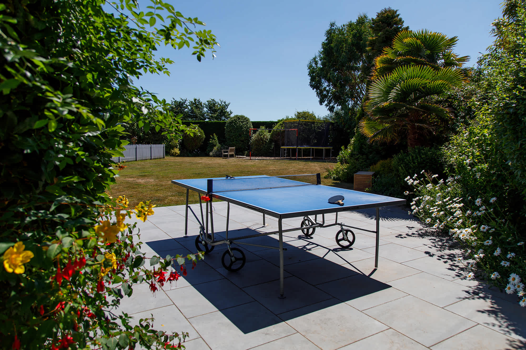 The home has two ping pong tables - one inside and one outside.