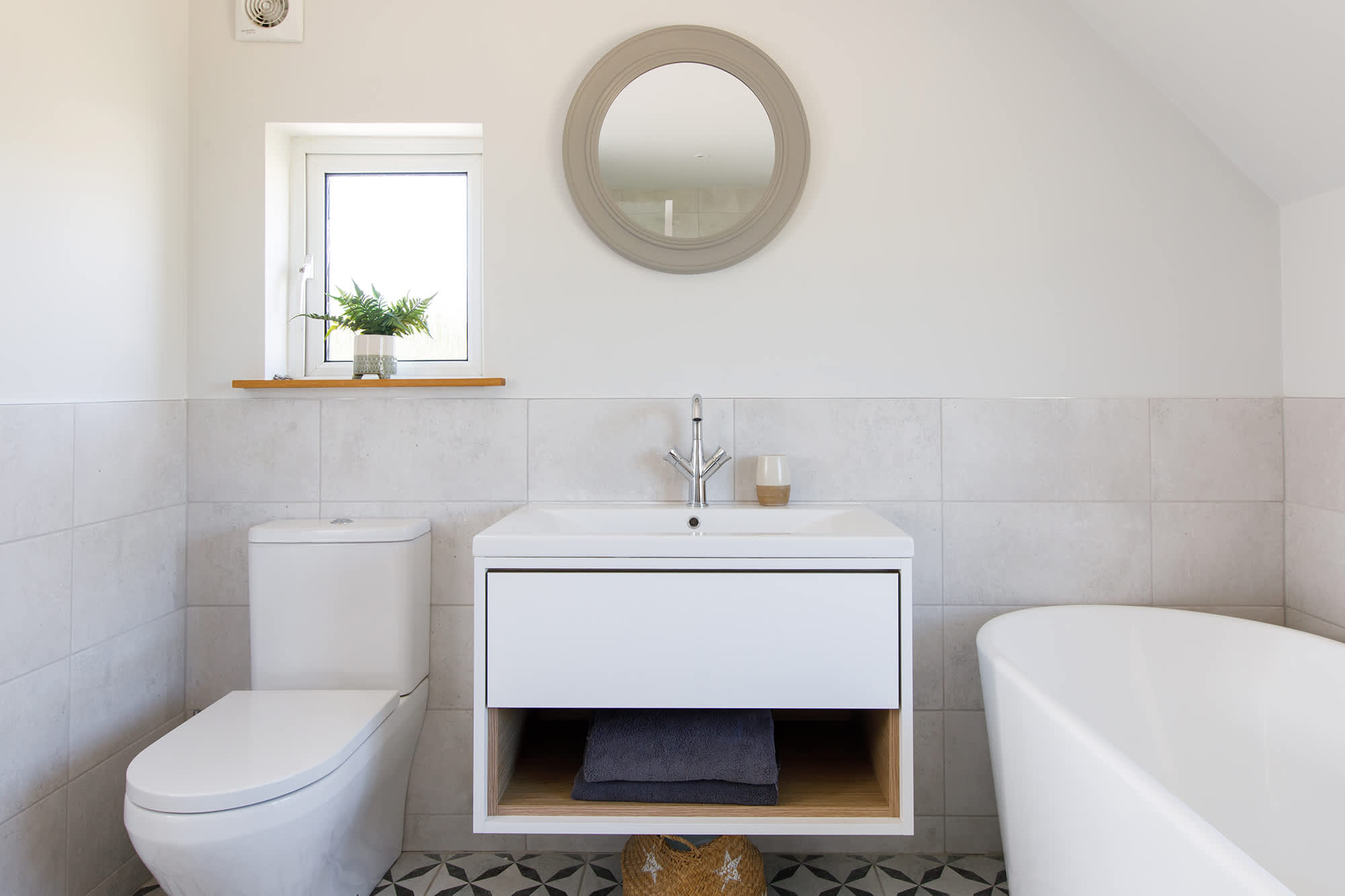 The master bedroom's ensuite had a deep, freestanding bath and vanity cabinet with sink and WC.
