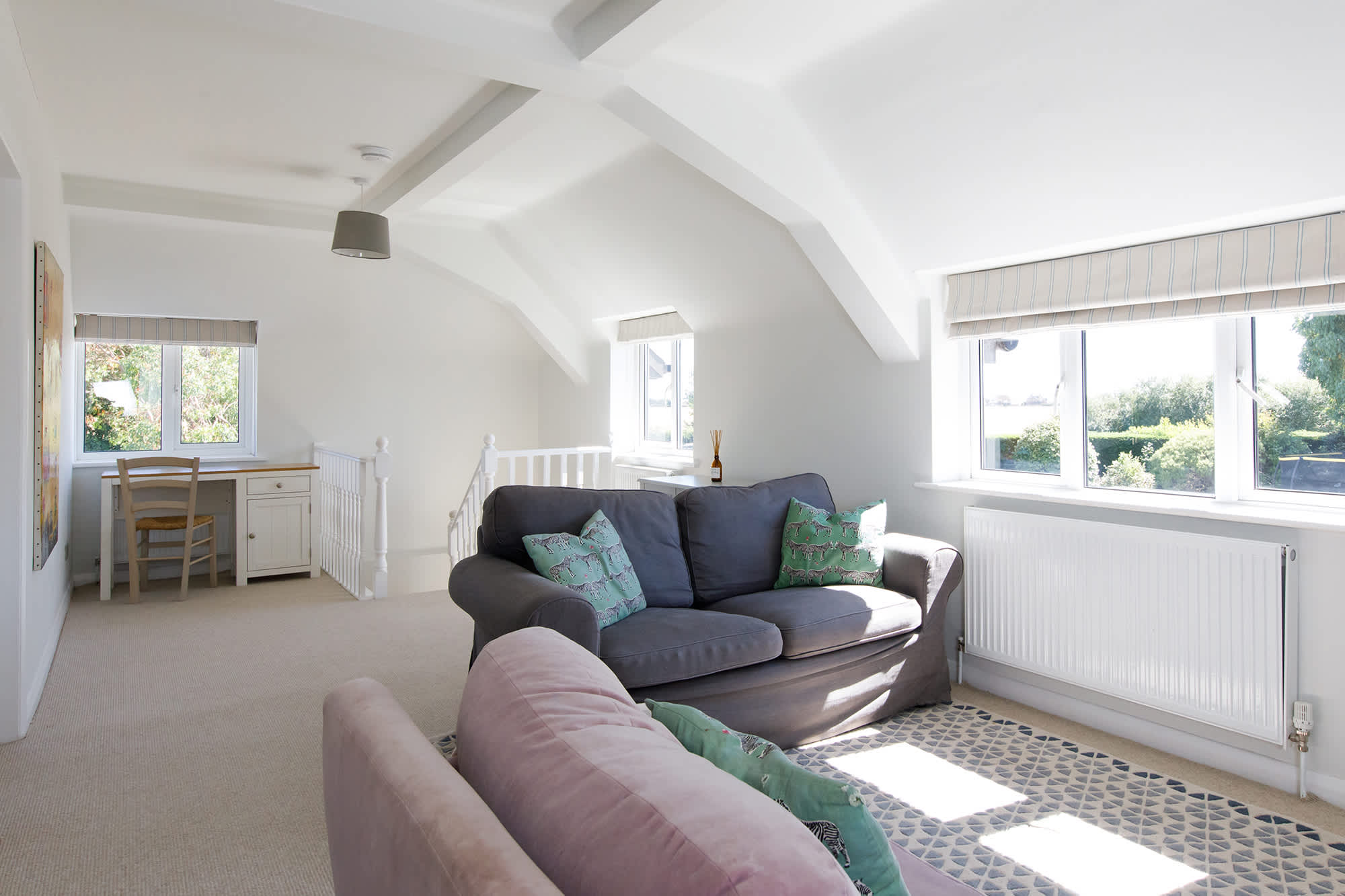 The impressive landing area offers a further snug area with sofas and TV, as well as desk space.