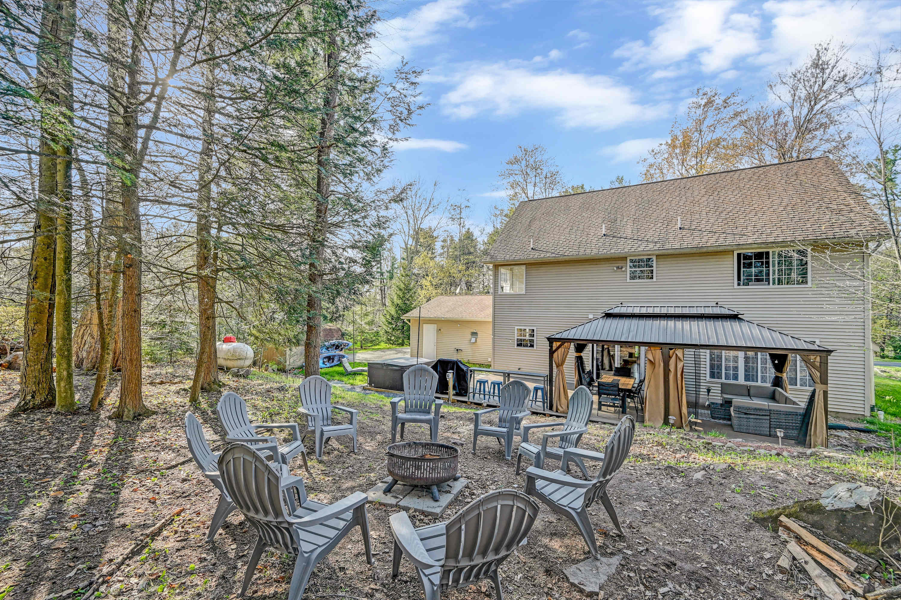 Outdoor Fun Awaits! With plenty of seating, a fire pit, and a serene wooded backdrop, this is the ultimate spot to relax and unwind.
