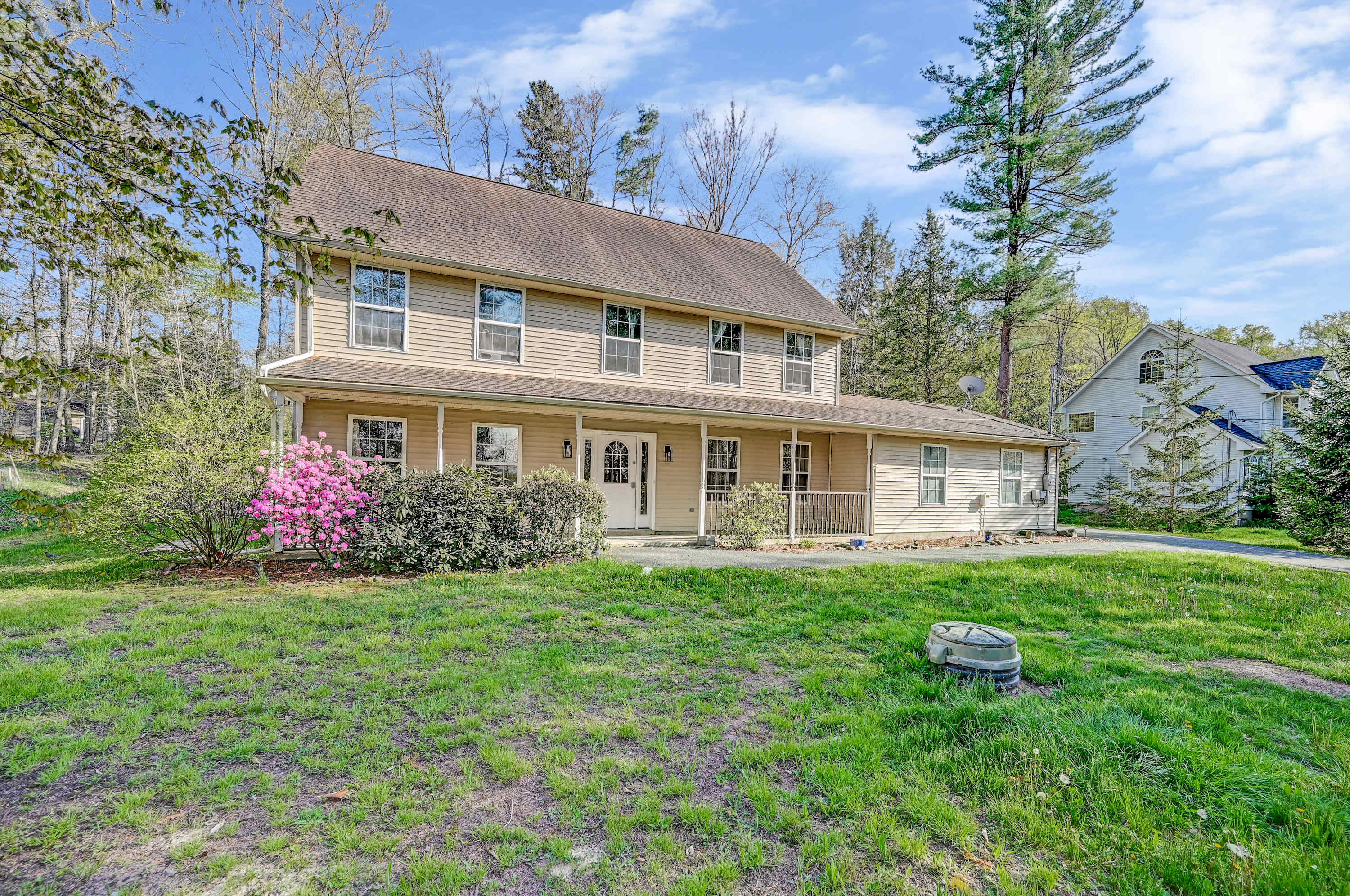 Charming Retreat! This beautiful two-story home offers a spacious front porch and a peaceful setting, perfect for your next getaway.