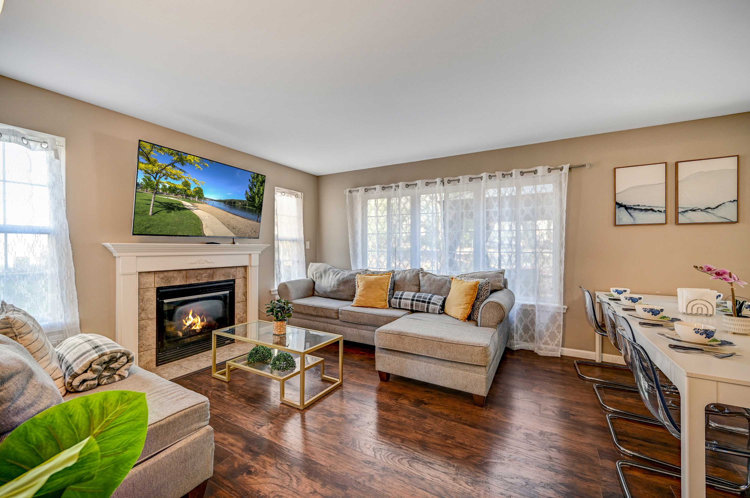 Elegant Comfort! Relax in this beautifully designed living space featuring a warm fireplace, plush seating, and a spacious dining area, perfect for gathering with loved ones.