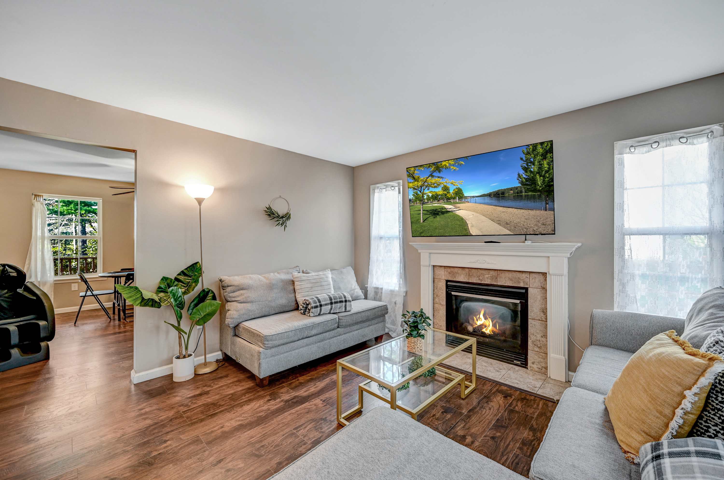 Modern Elegance! With warm wooden floors, stylish furnishings, and an open flow from entryway to living room, this space is ideal for entertaining or unwinding.