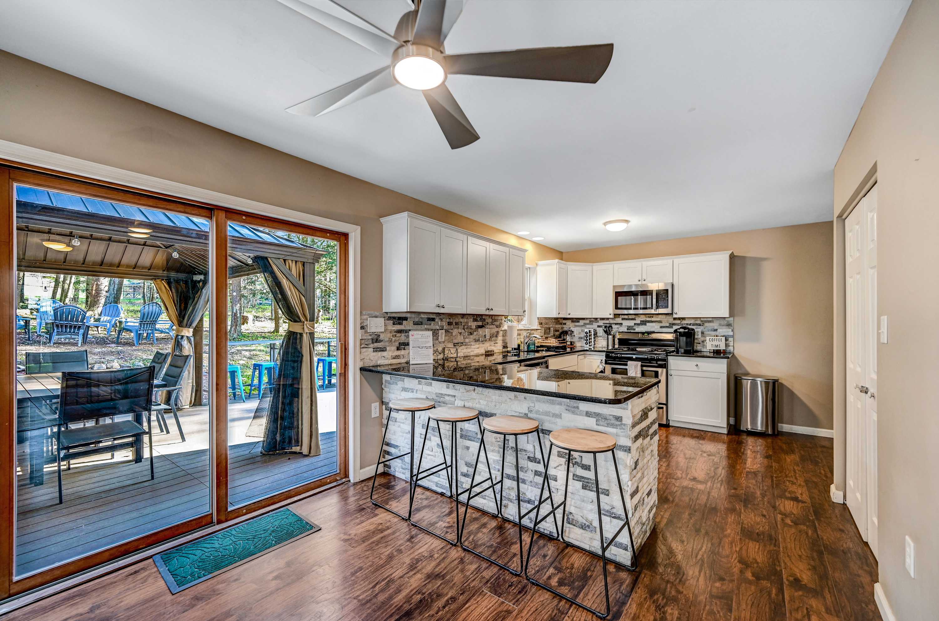 From Breakfast to Happy Hour! Whether you're whipping up a feast or sipping wine at the island, this space is designed for comfort and connection, with the perfect patio view to match!