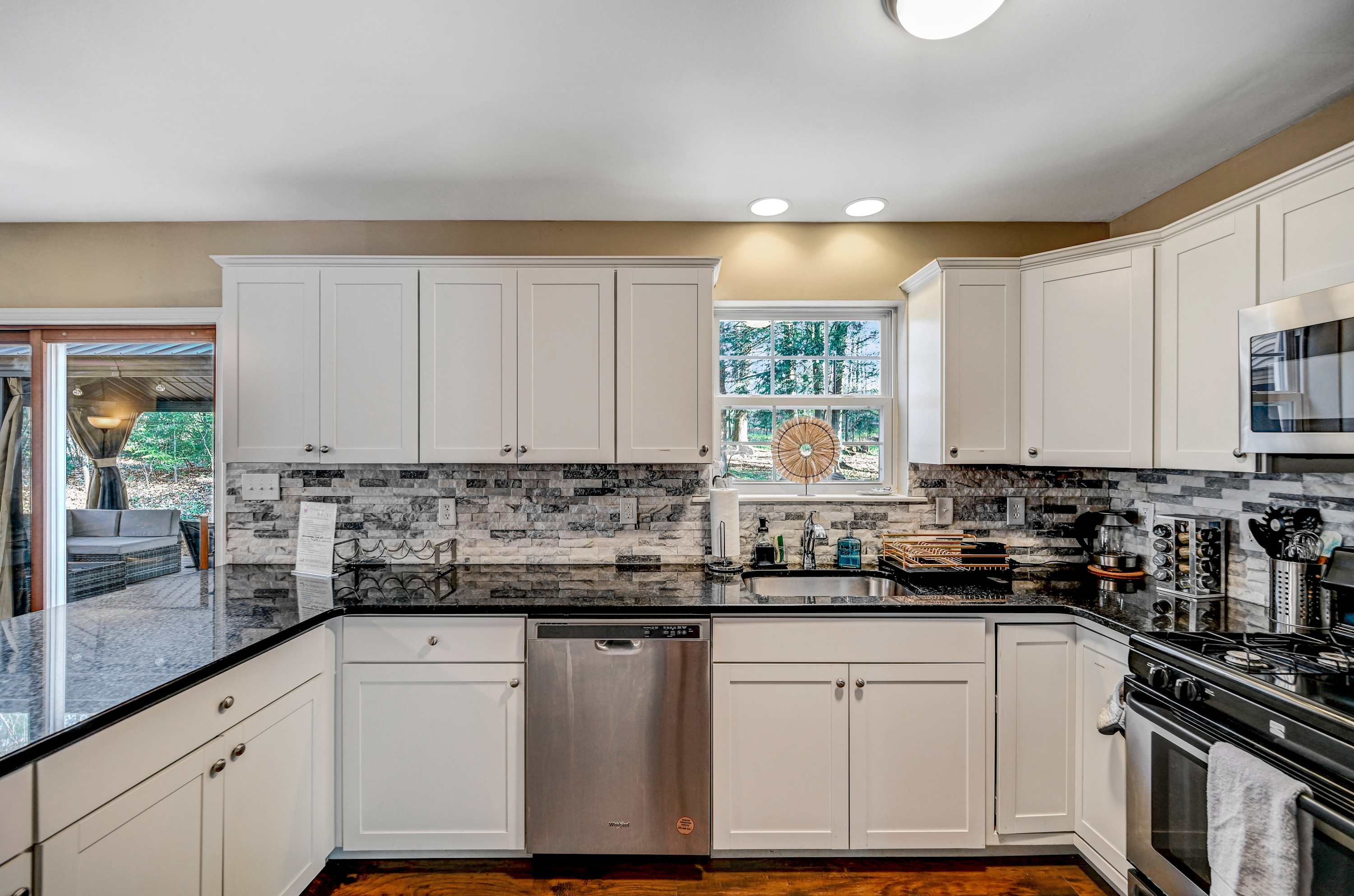 The Heart of the Home! This thoughtfully designed kitchen offers plenty of counter space, stainless steel appliances, and a chic backsplash, perfect for whipping up meals with ease. 