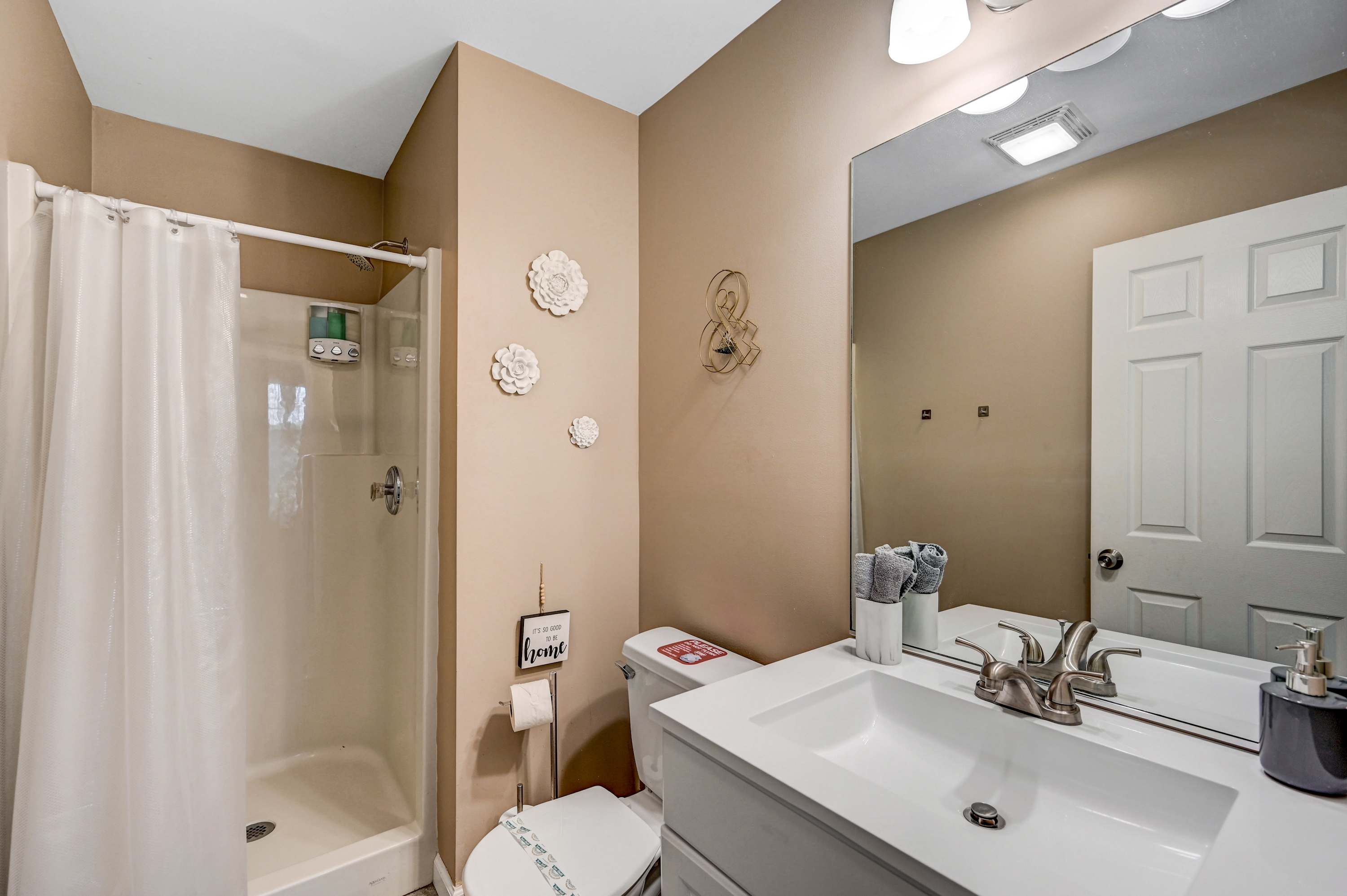Bright, Clean & Refreshing! Start your day in this well-appointed bathroom, featuring a walk-in shower, fresh towels, and a calming aesthetic.