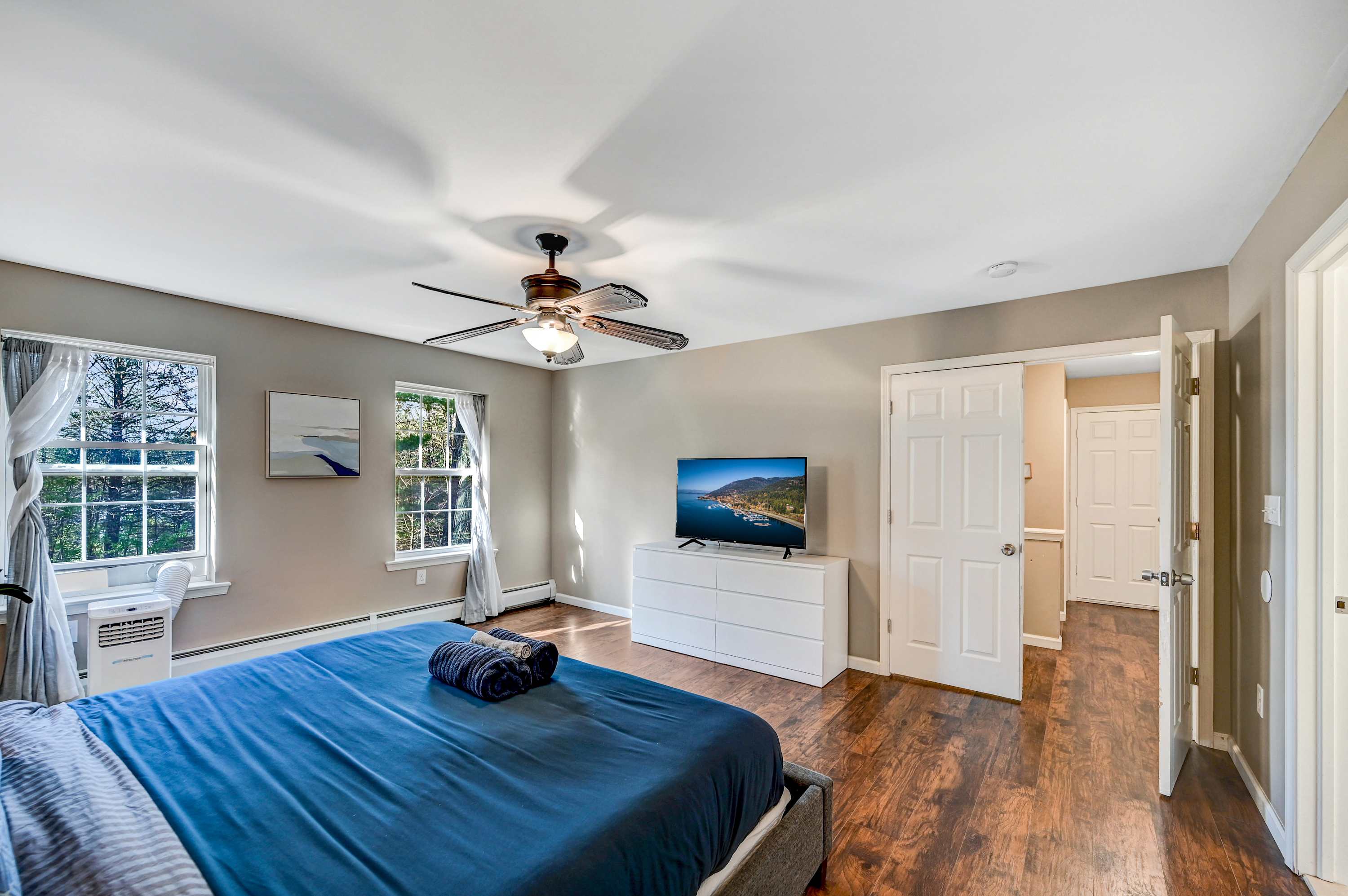 Unwind in Style! Sink into the plush bedding, enjoy the scenic view, and catch up on your favorite shows in this bright and airy master suite.