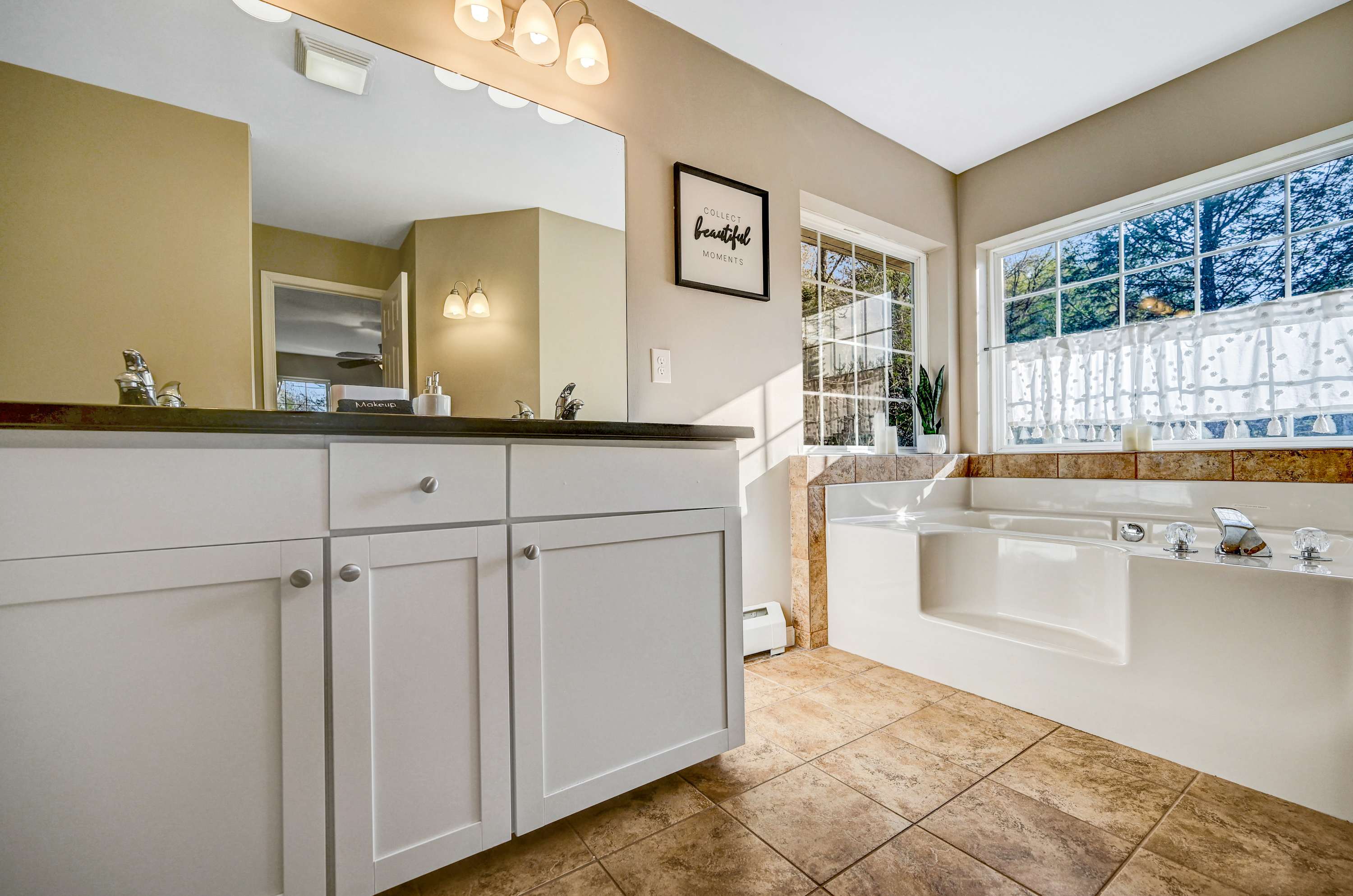 Your Private Retreat! Whether you’re indulging in a bubble bath or getting ready for the day, this stylish and well-lit bathroom has everything you need.