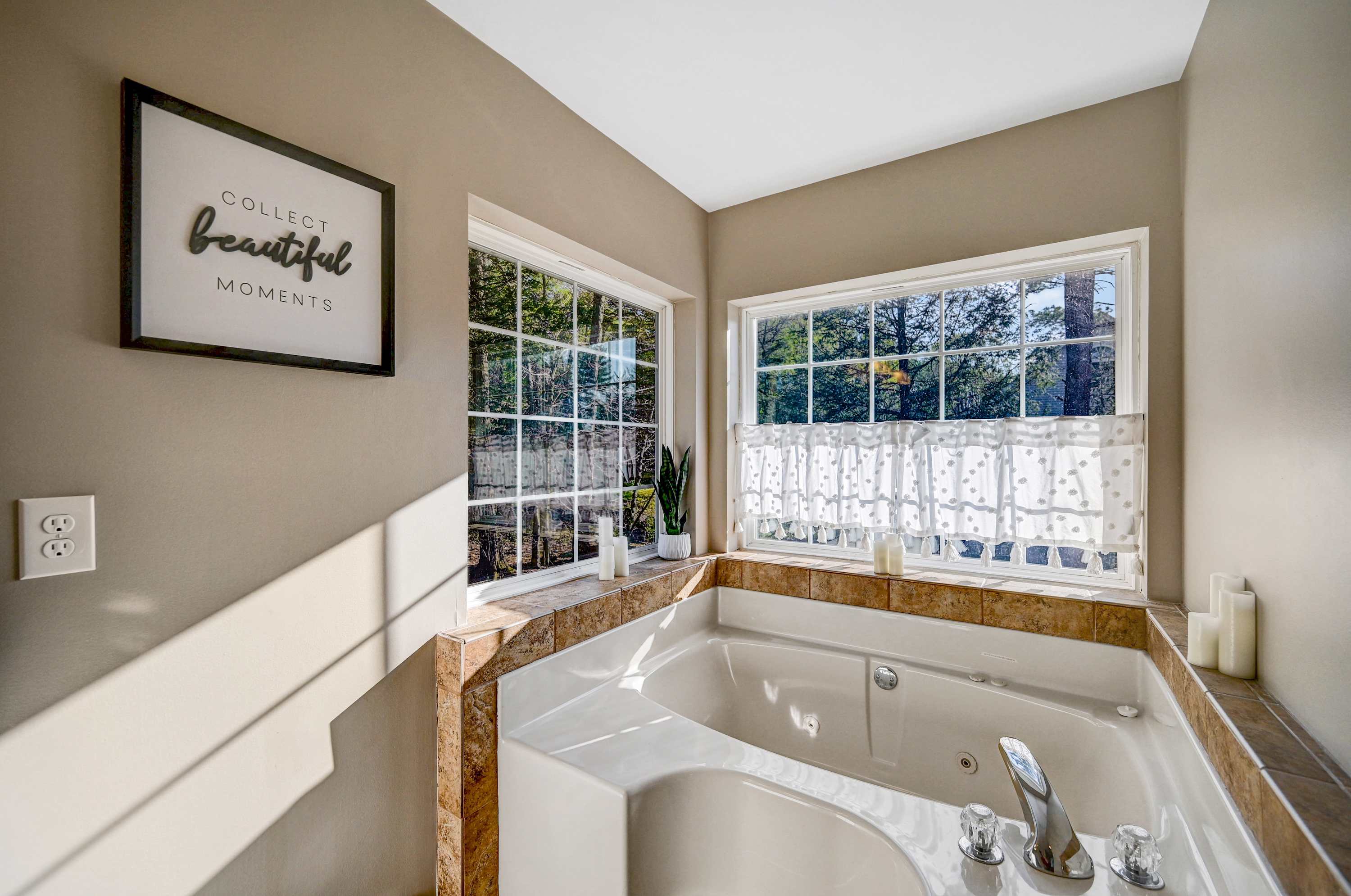 Spa-Like Serenity! Soak in the luxurious tub, enjoy the warm natural light, and refresh in this bright and beautifully designed bathroom.