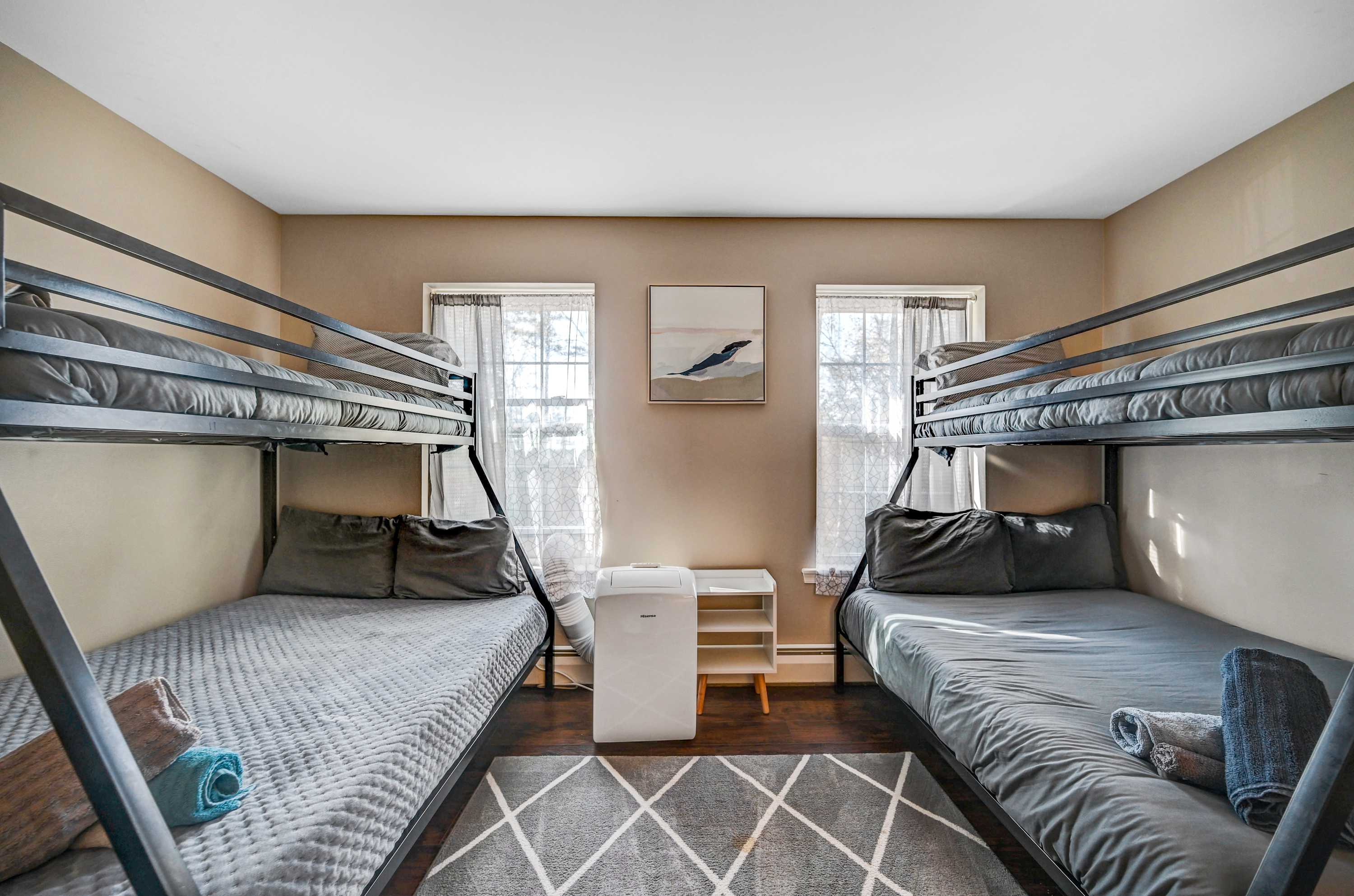 Perfect for Groups & Families! With two sturdy bunk beds, plush bedding, and natural light, this room is a dream for kids and adults alike!