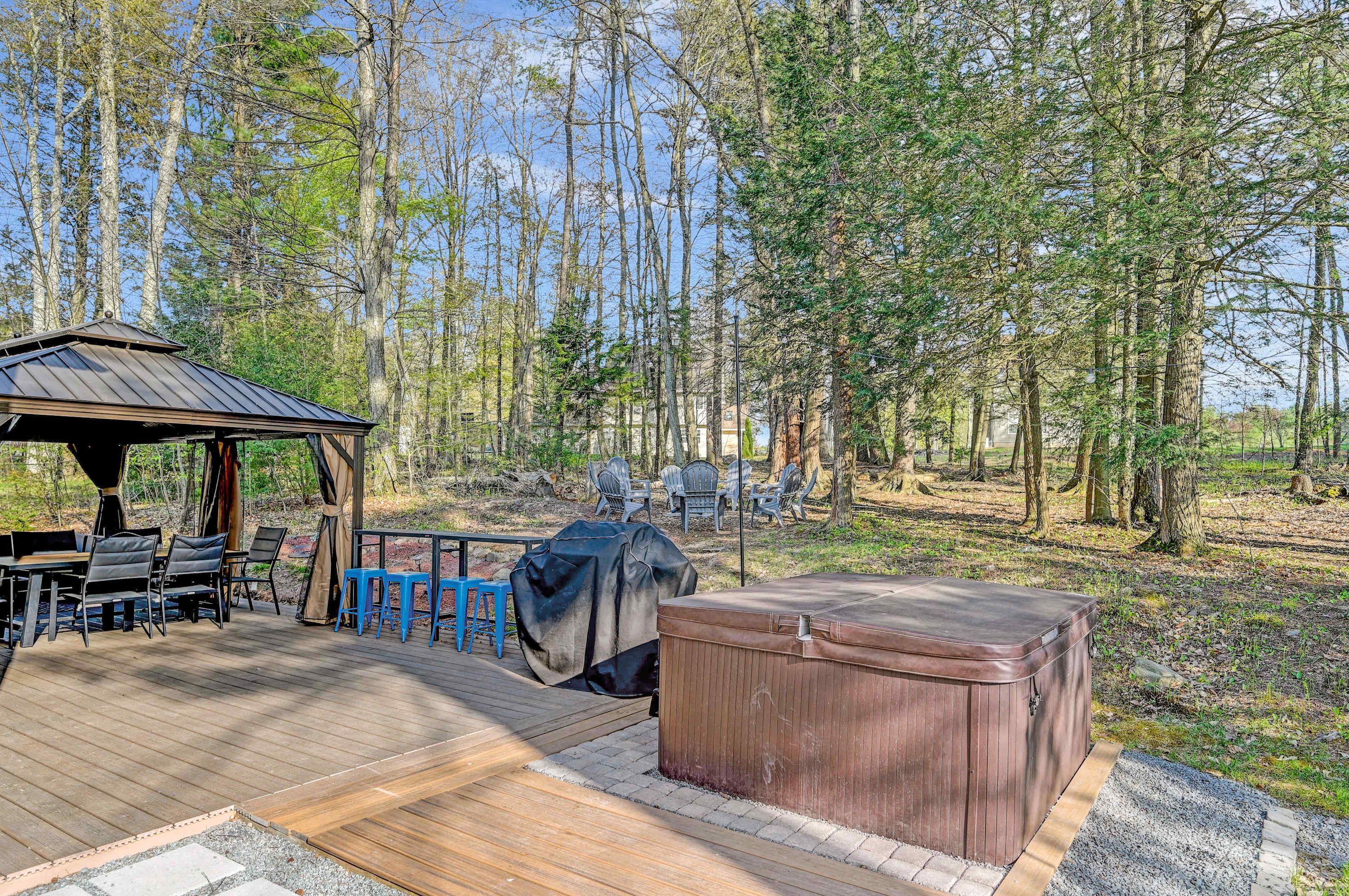 Nature & Relaxation Combined! Unwind in the hot tub, grill up a feast, and dine under the gazebo in this tranquil backyard retreat.