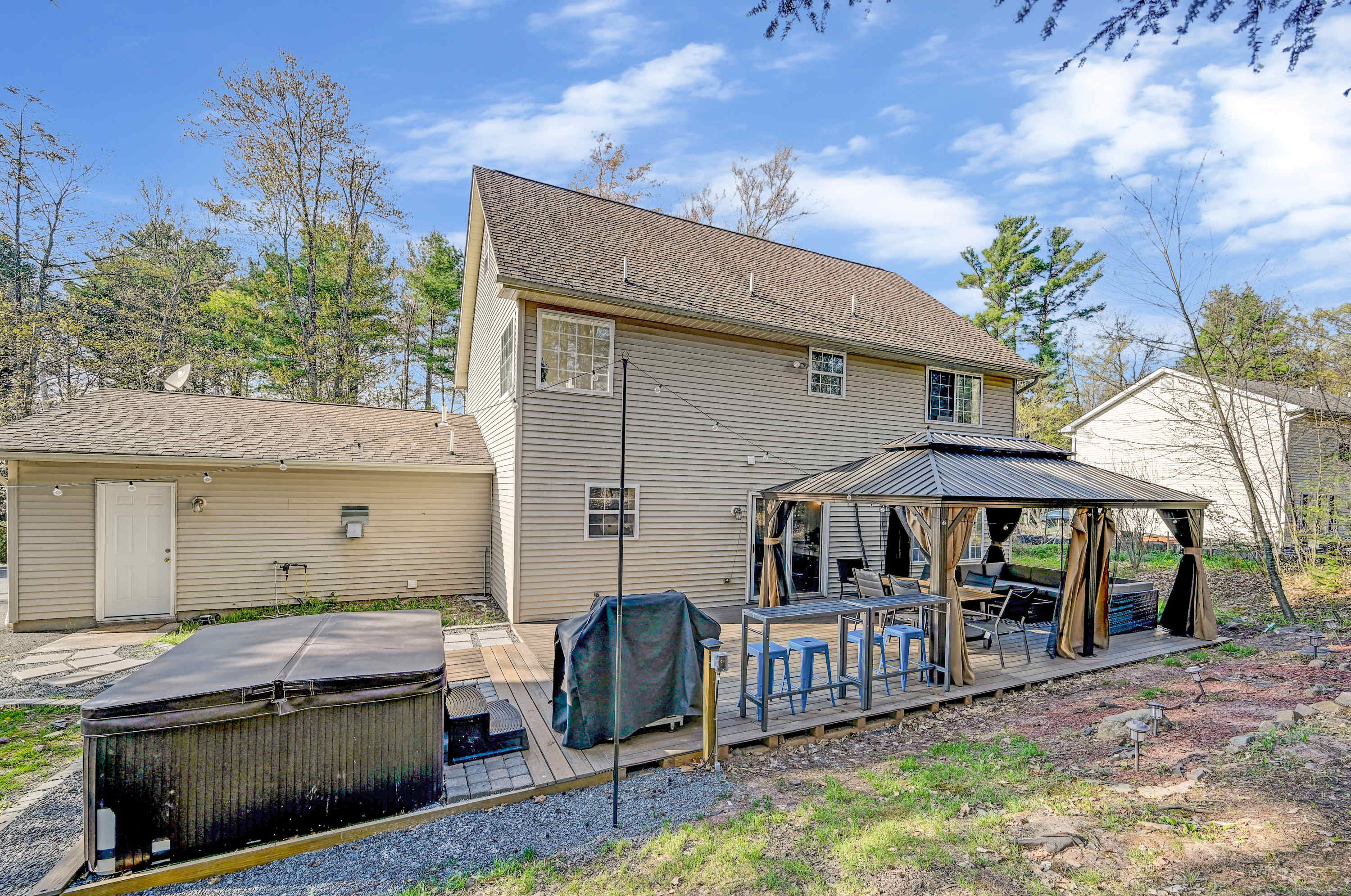 Outdoor Oasis! Unwind in the hot tub, grill out under the gazebo, and enjoy the fresh air in this private backyard retreat.