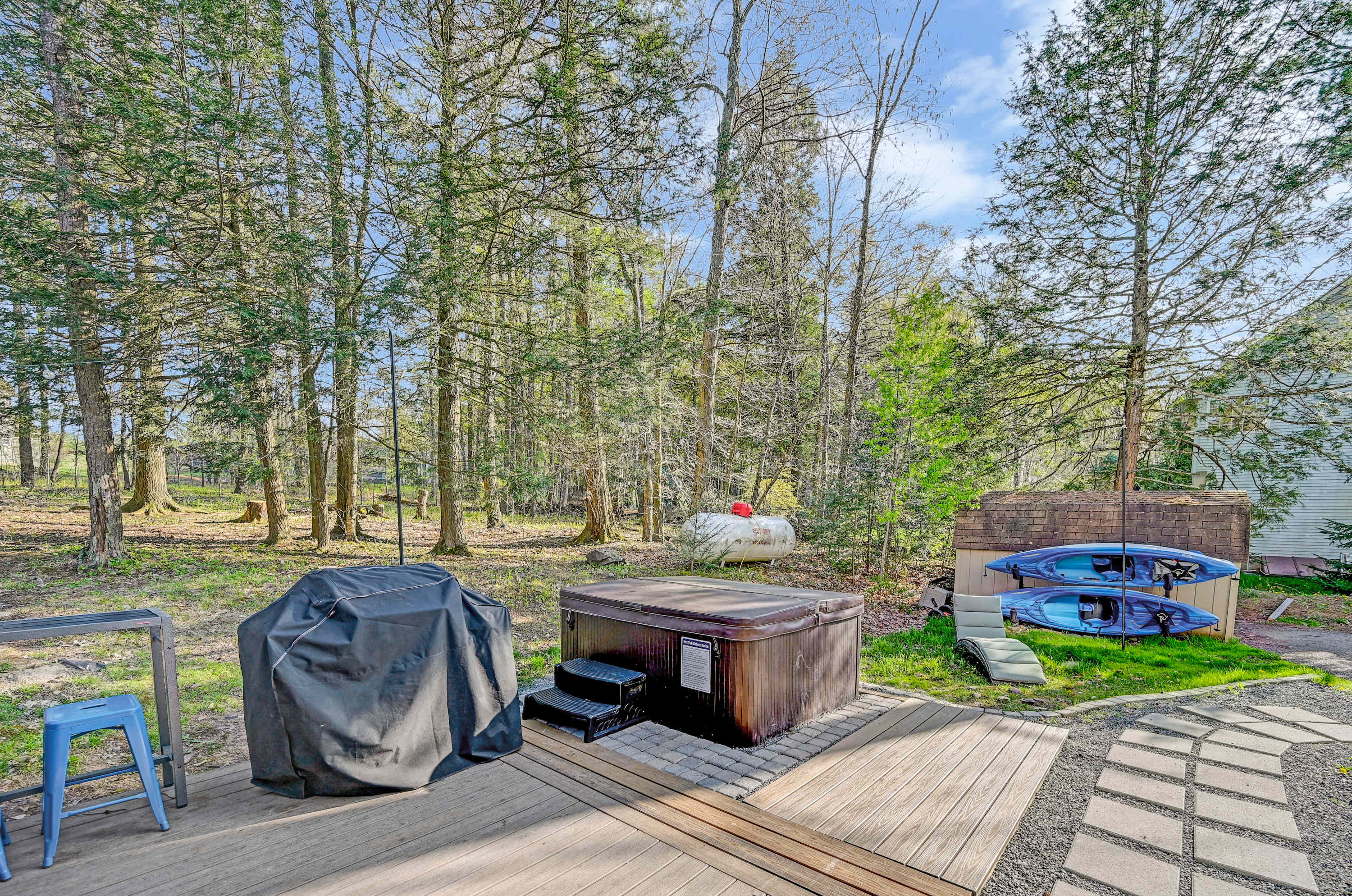 Scenic Backyard Oasis! Enjoy forest views, a rejuvenating hot tub, and kayaks ready for exploration. Perfect for making memories!