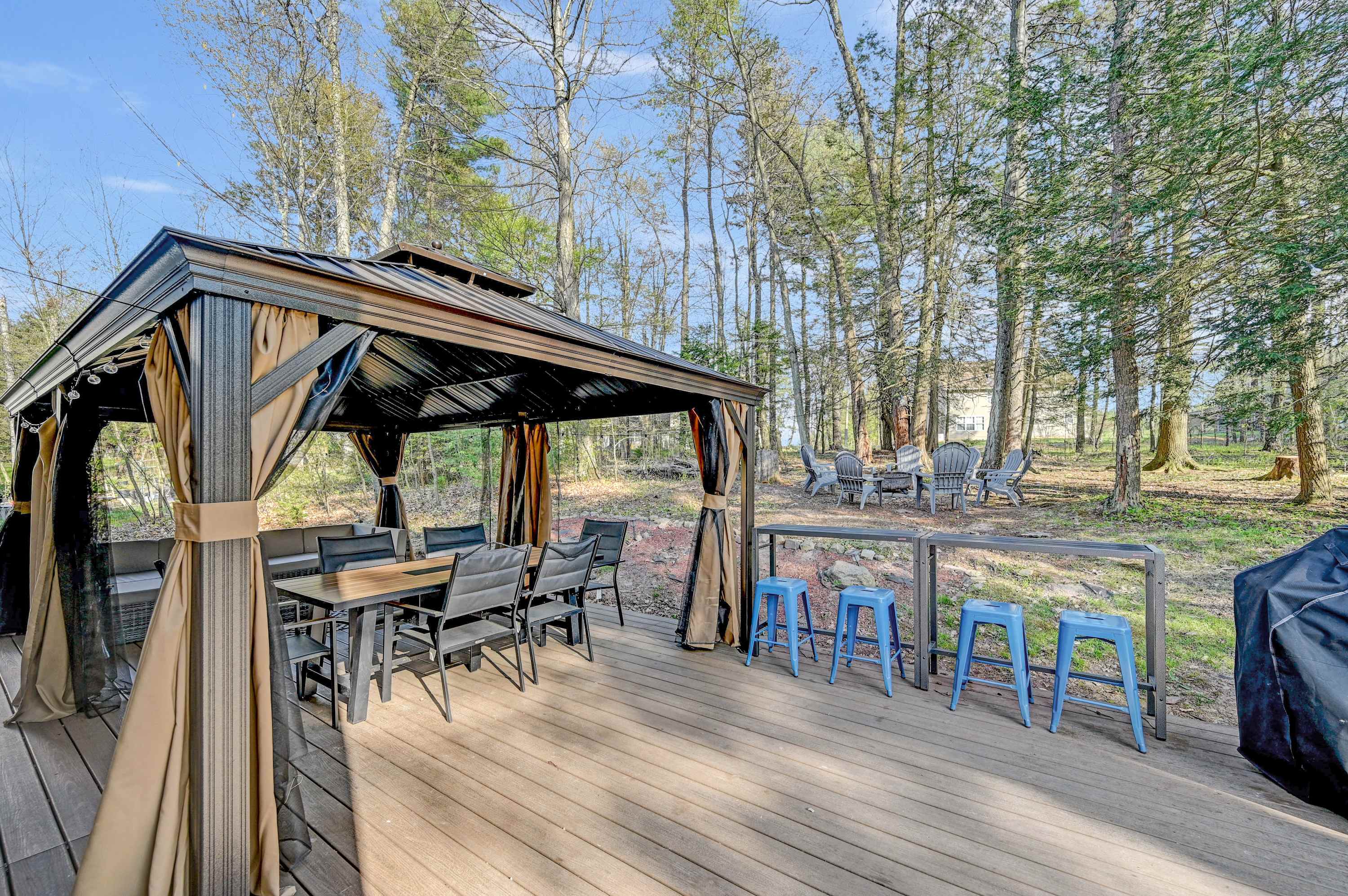 Al Fresco Haven! Dine under the gazebo, gather around the fire pit, and soak in peaceful woodland views.