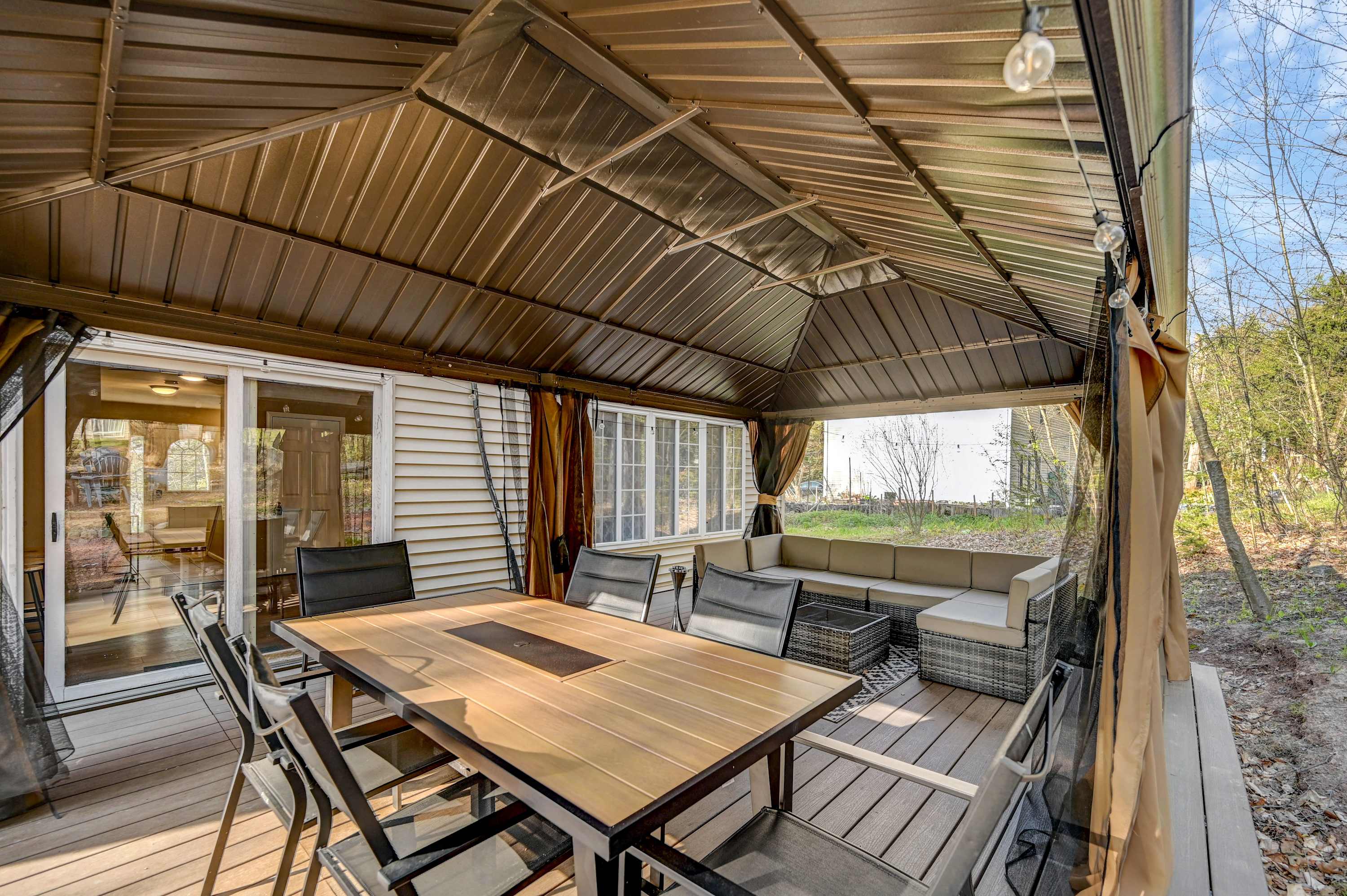 Cozy Gazebo Retreat! Enjoy meals or morning coffee in this covered space, complete with plush seating and fresh forest air.