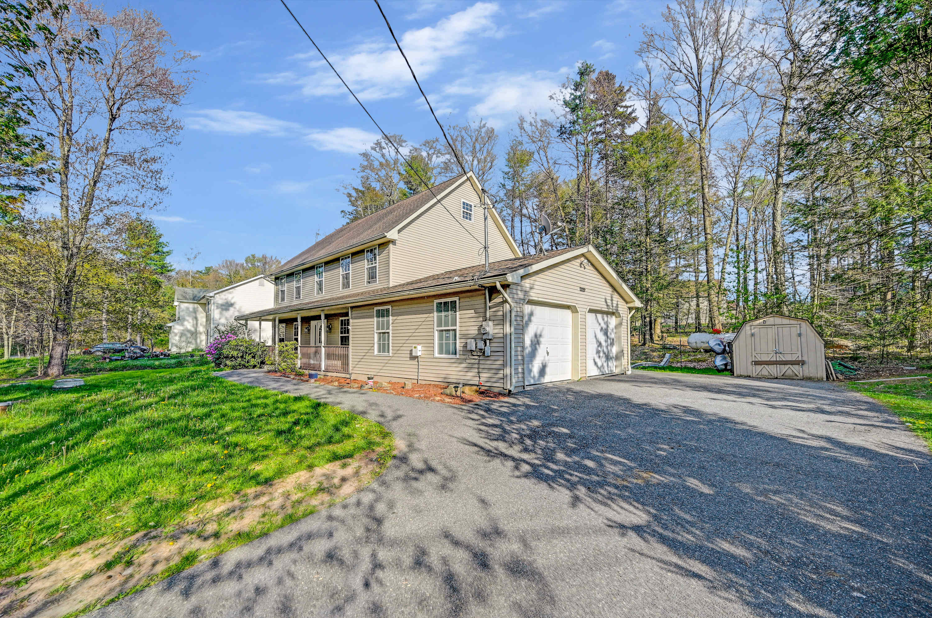 Your Peaceful Haven! Nestled among tall trees, this home offers plenty of parking and a porch made for lazy afternoons.