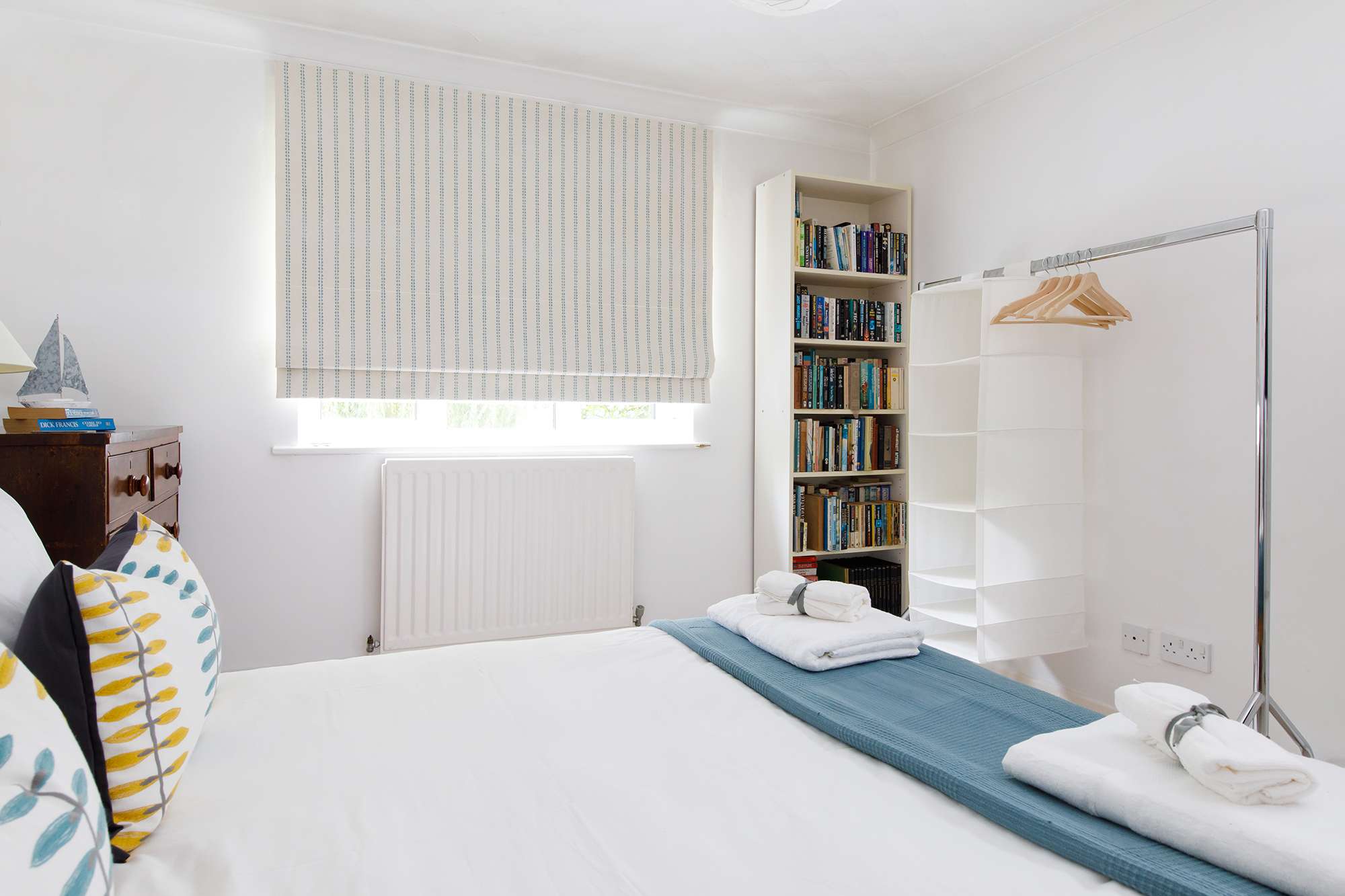 The second room downstairs has a king bed and plenty of reading material.