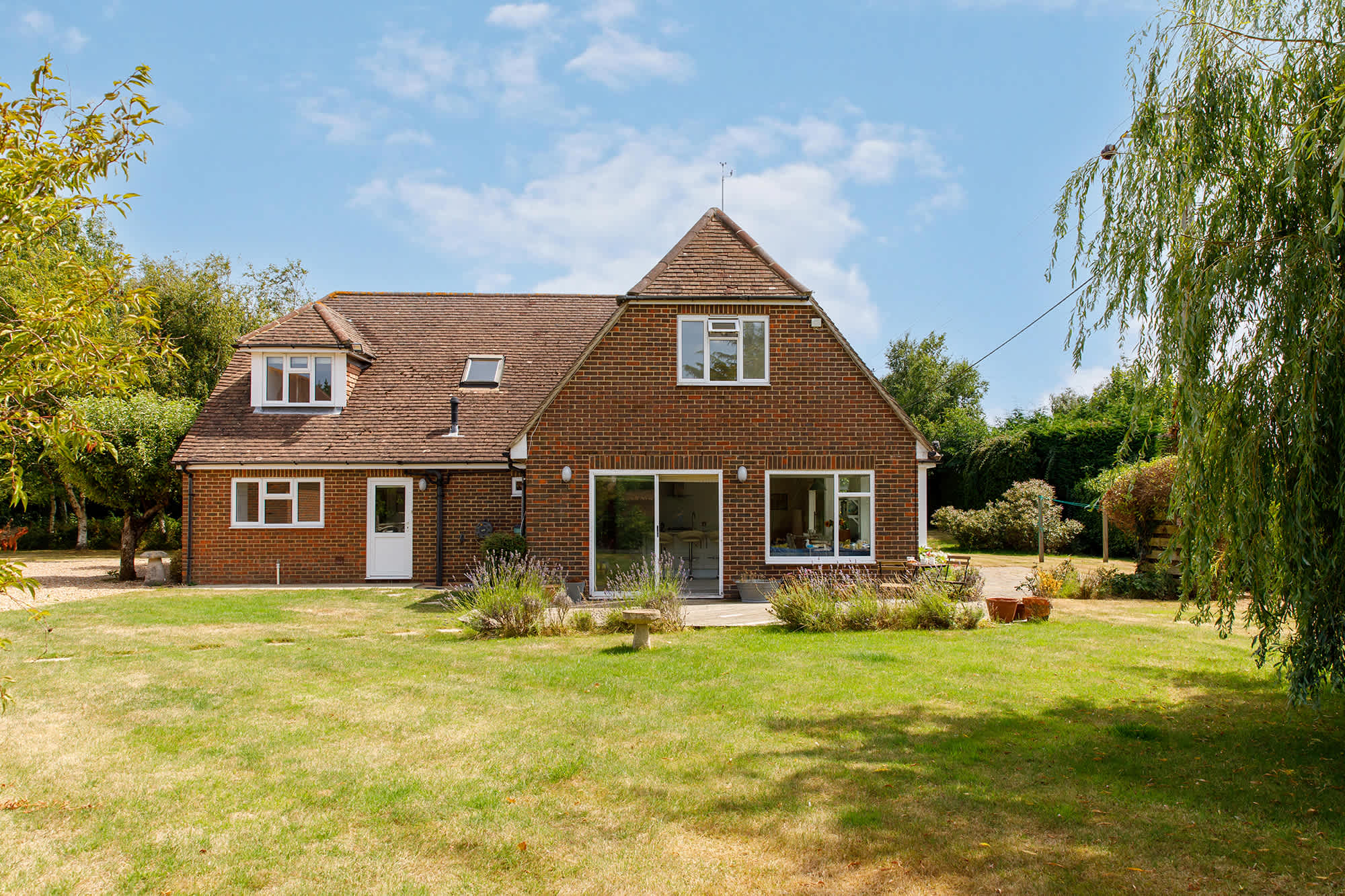 The garden is just under one acre and is surrounded by trees and shrubs.