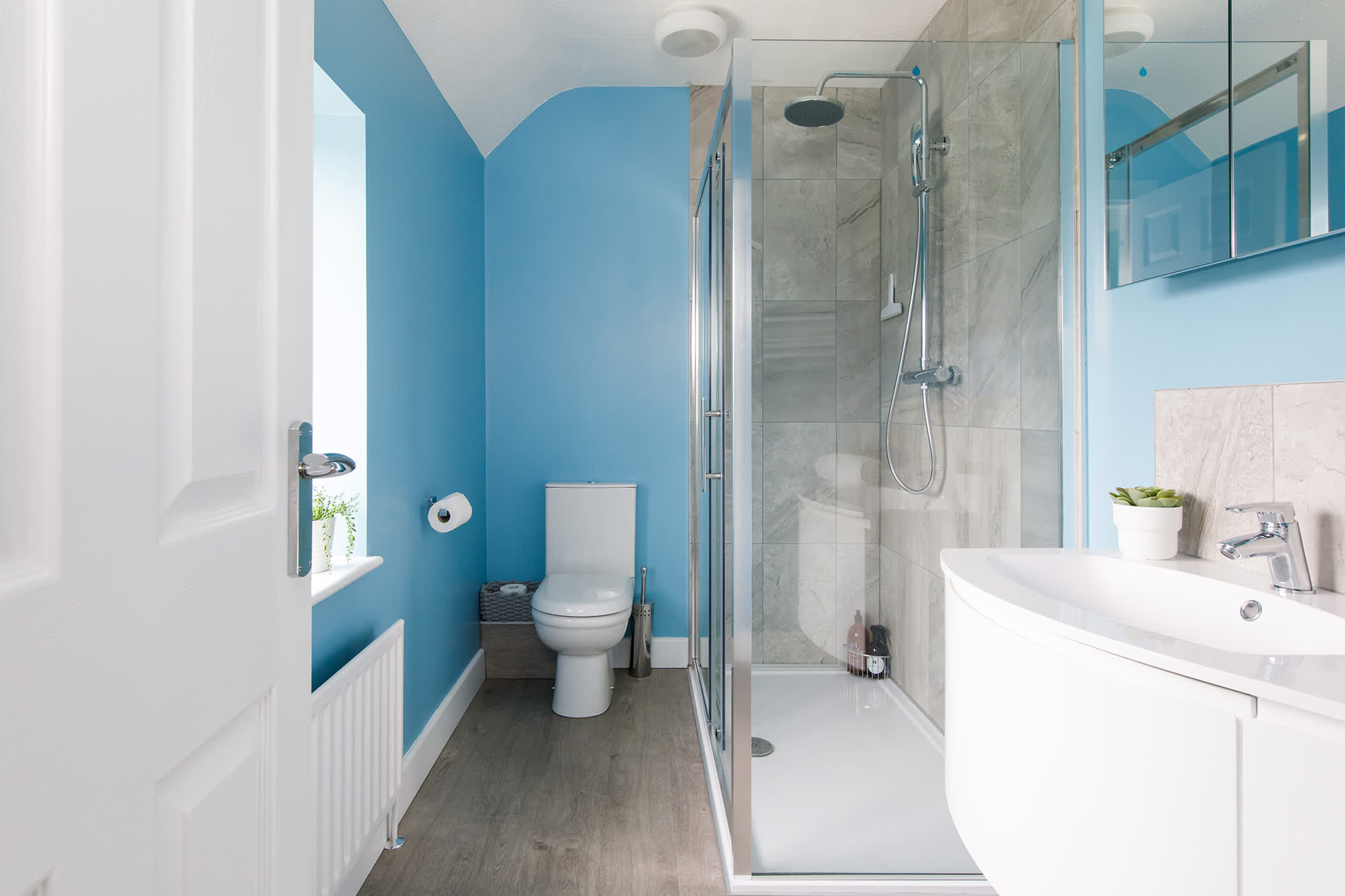 The master bedroom has a bright ensuite, with spacious walk-in shower, sink and WC.