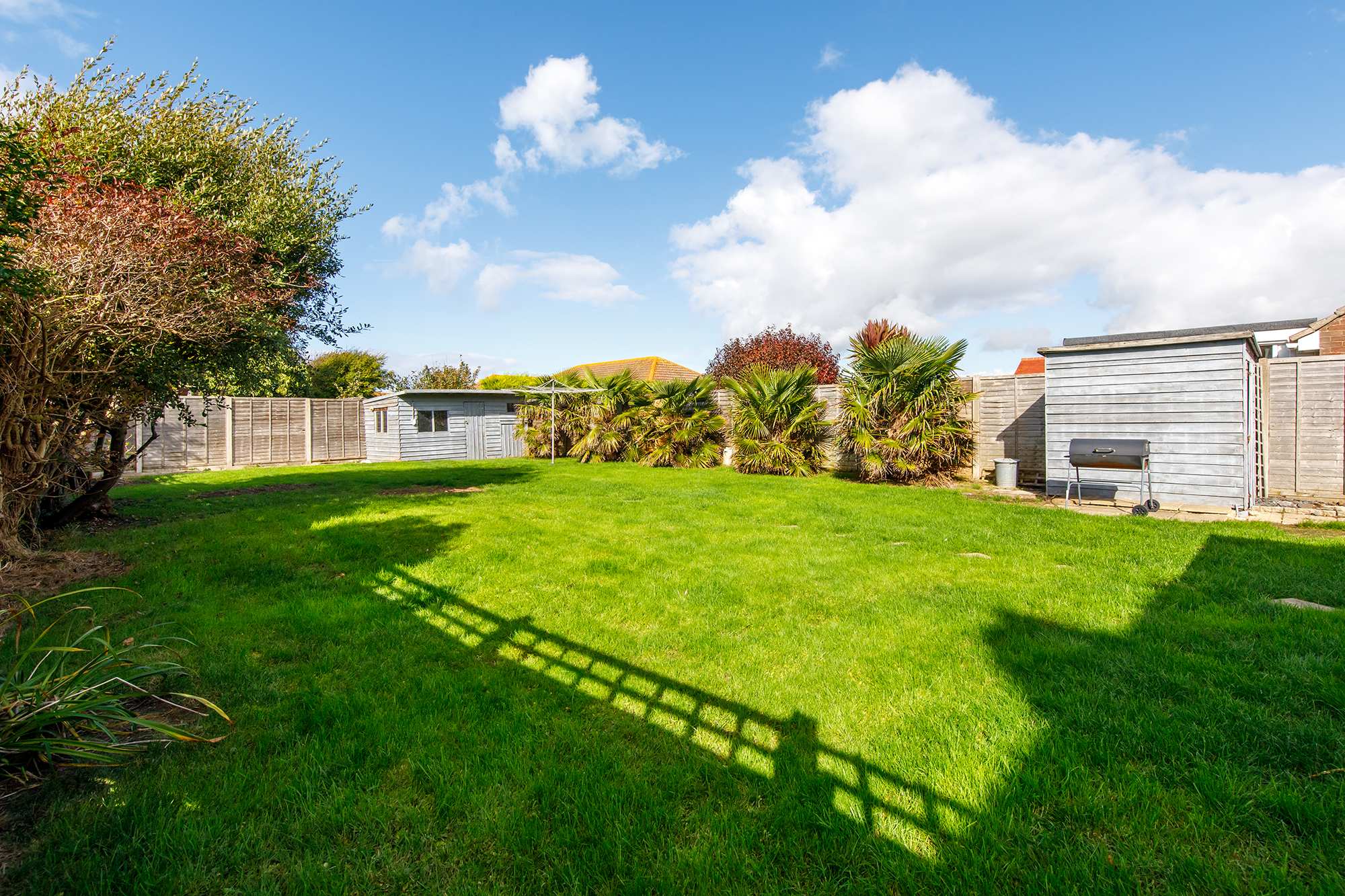 Relax in the lush green garden with a BBQ or cold drink.