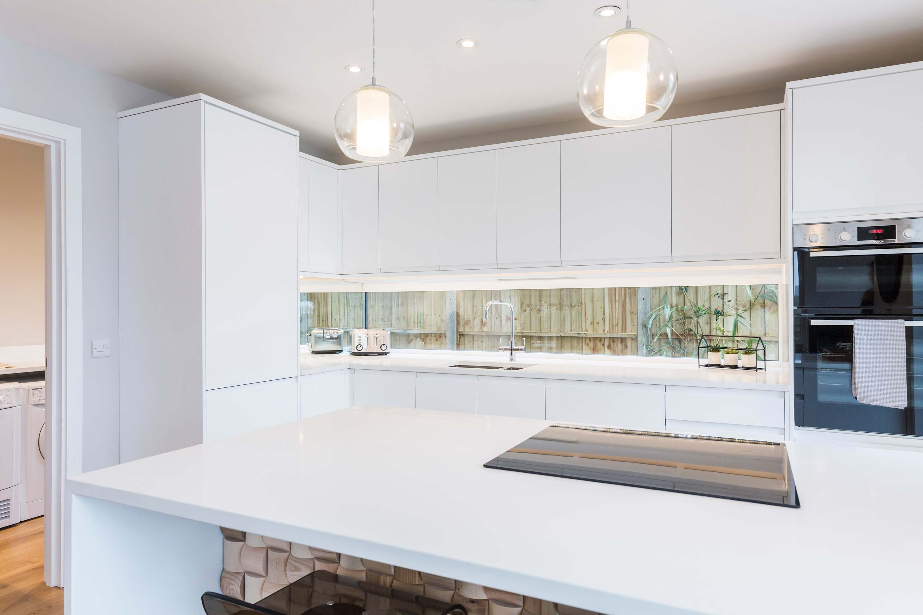 How's this for a stylish kitchen with sleek white cabinets?